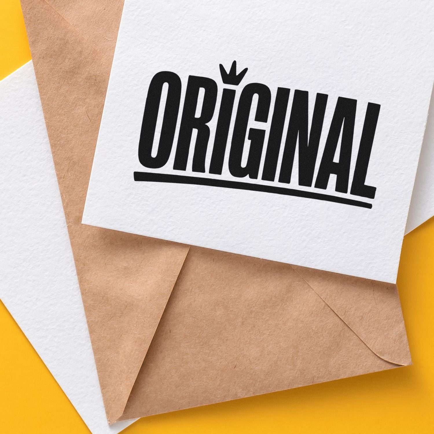 White card with bold black ORIGINAL stamp on kraft paper envelopes against a bright yellow background.