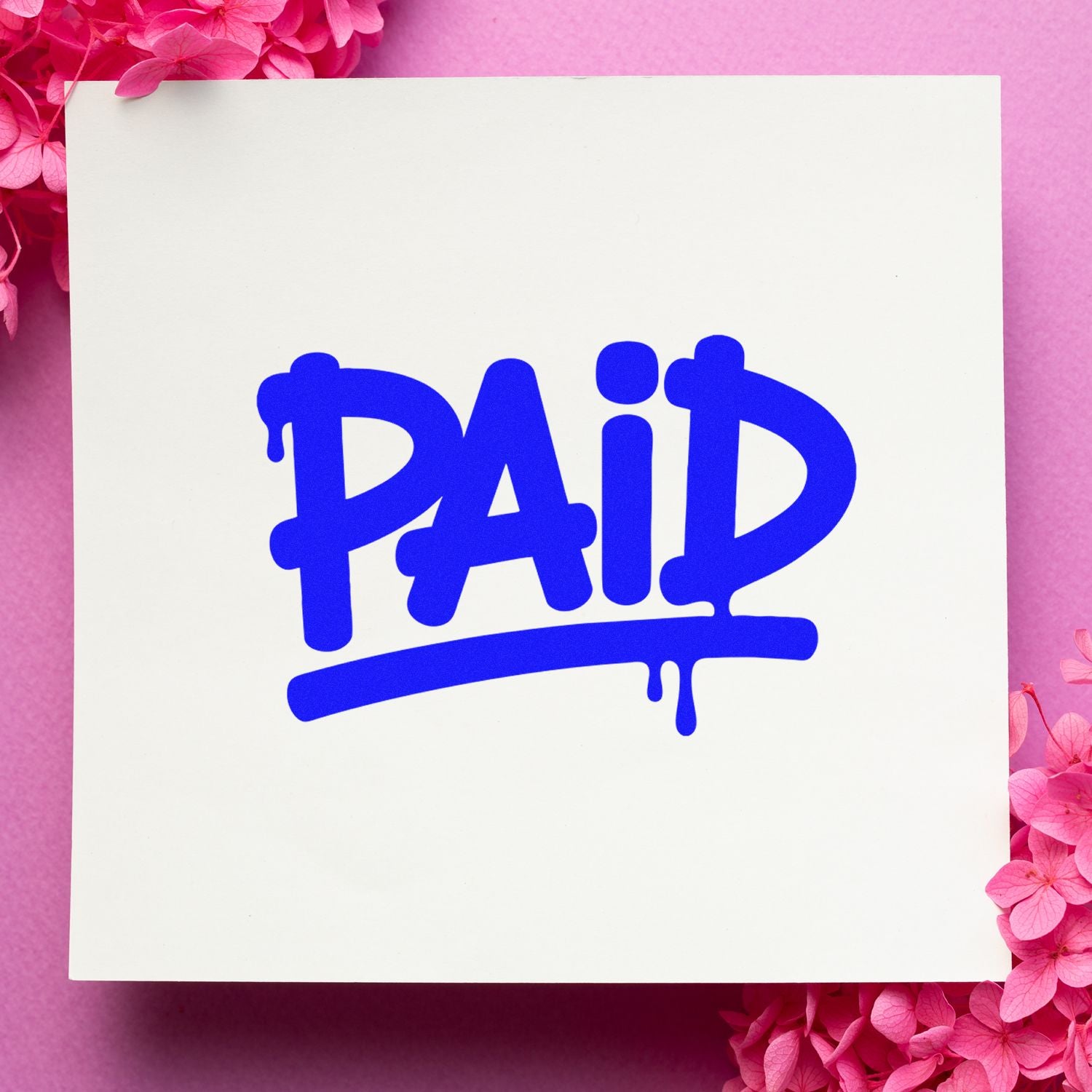 Blue PAID stamp seal on a white card, with dripping letters, surrounded by pink flowers on a pink background.