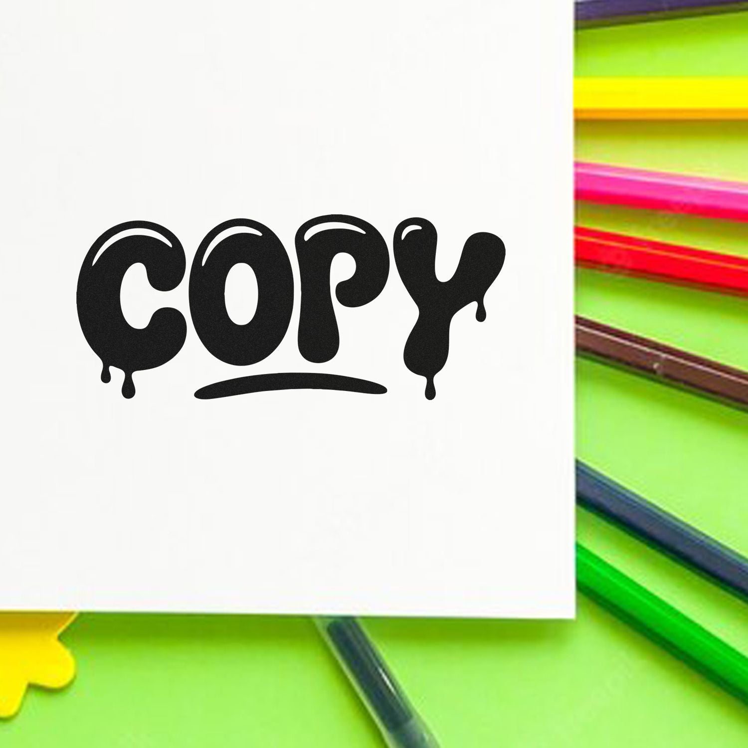 Black dripping COPY stamp on white paper with neon green, pink and yellow seal products in background