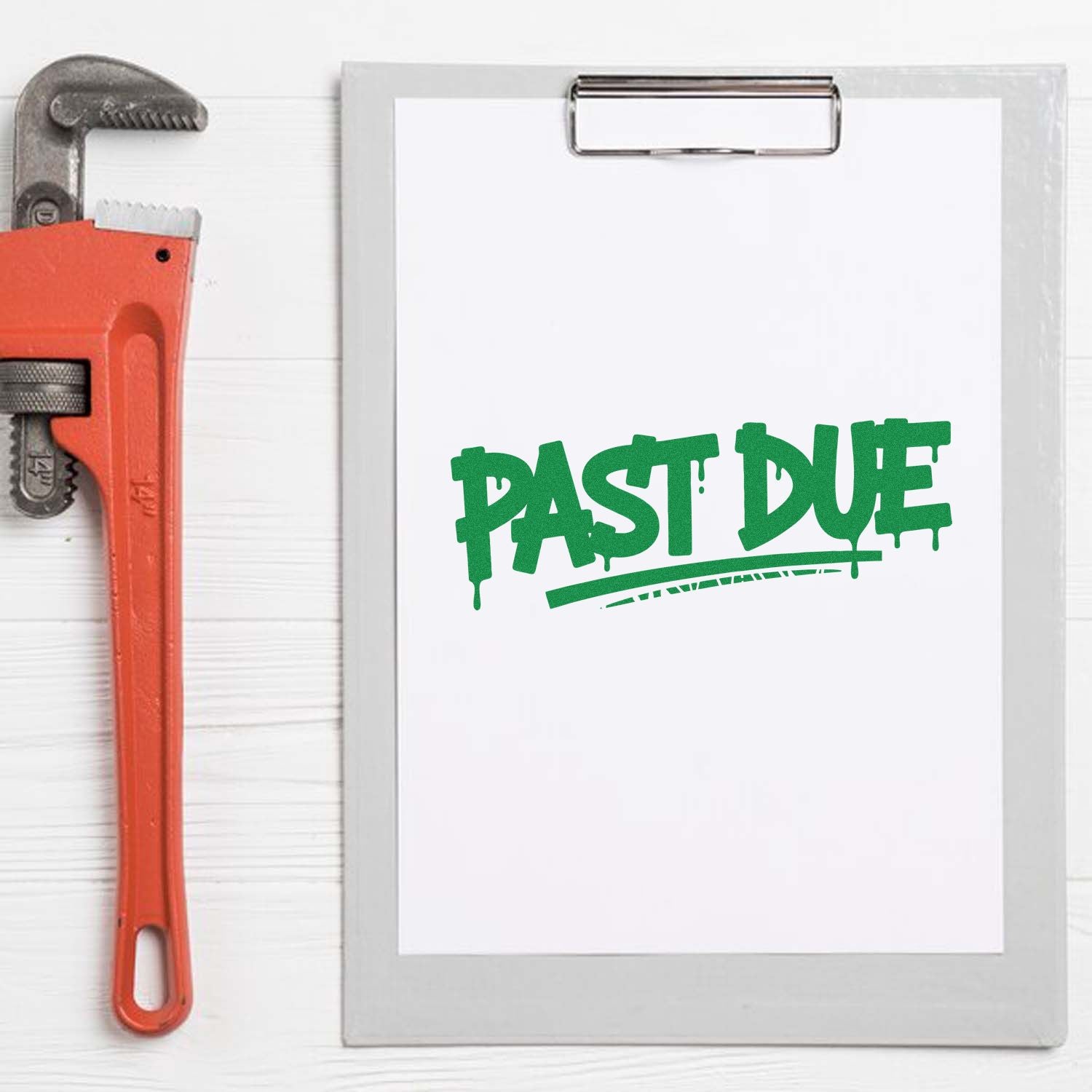 Green PAST DUE stamp and seal on white clipboard, beside a red pipe wrench.