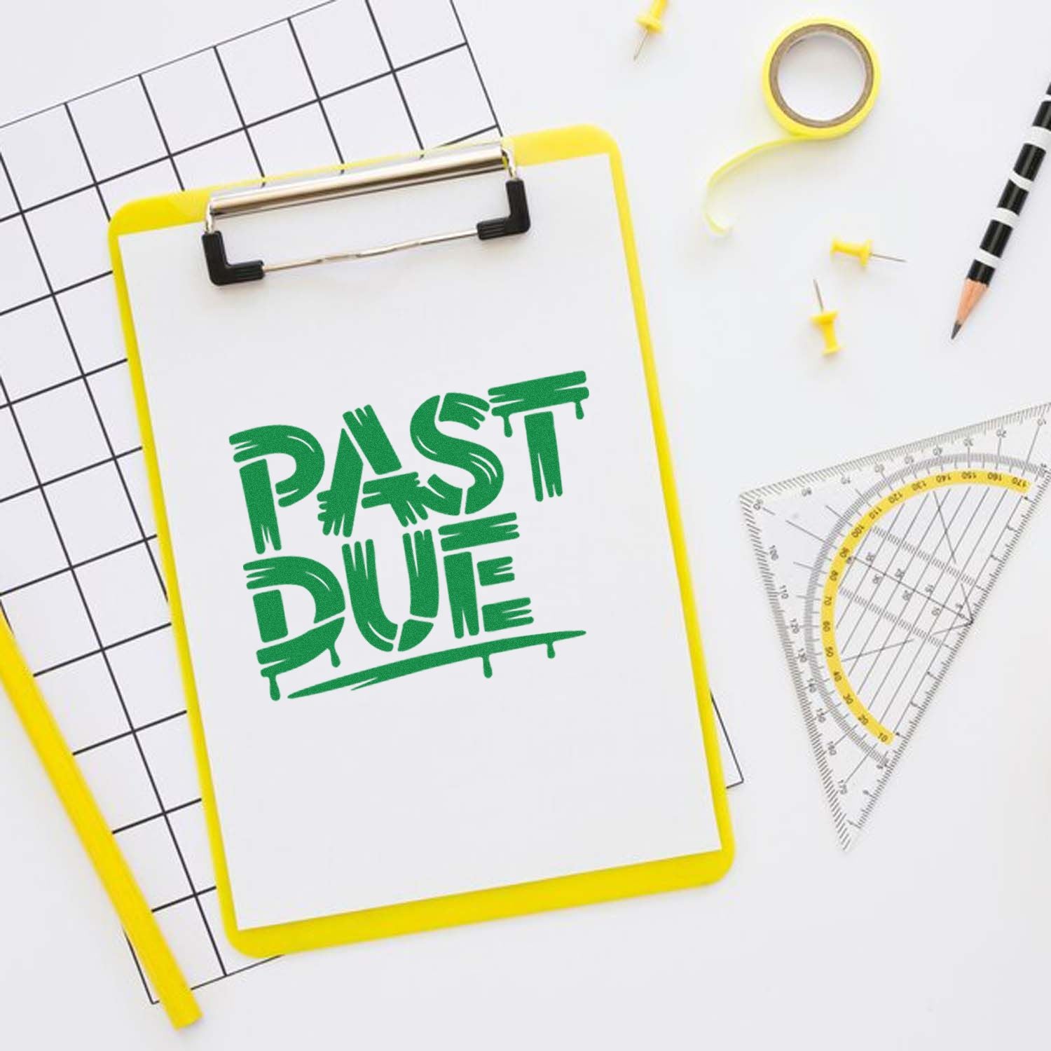 Green PAST DUE stamp on yellow clipboard, with black grid paper, yellow tape, pencil, and protractor.