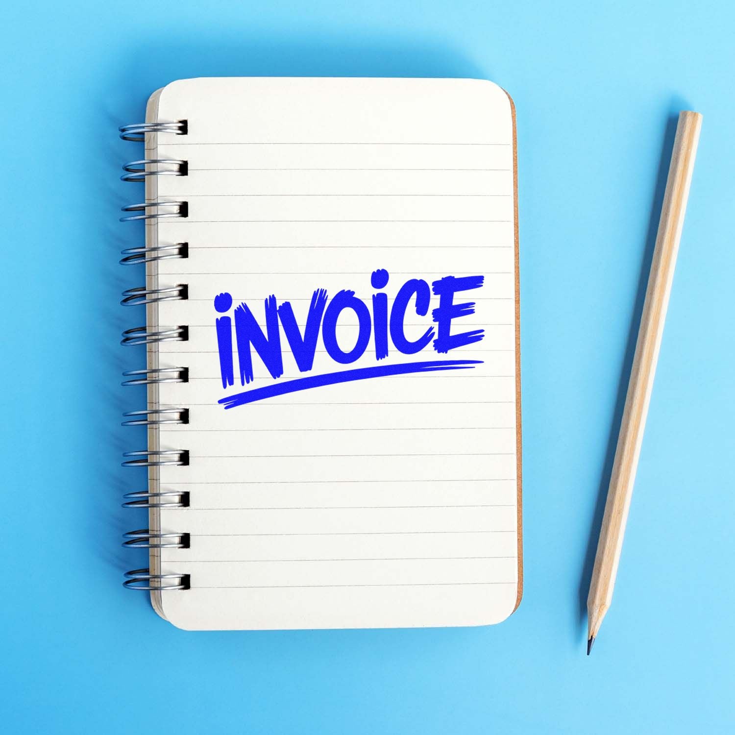 Blue invoice stamp on a white spiral notebook with a pencil on a light blue background.