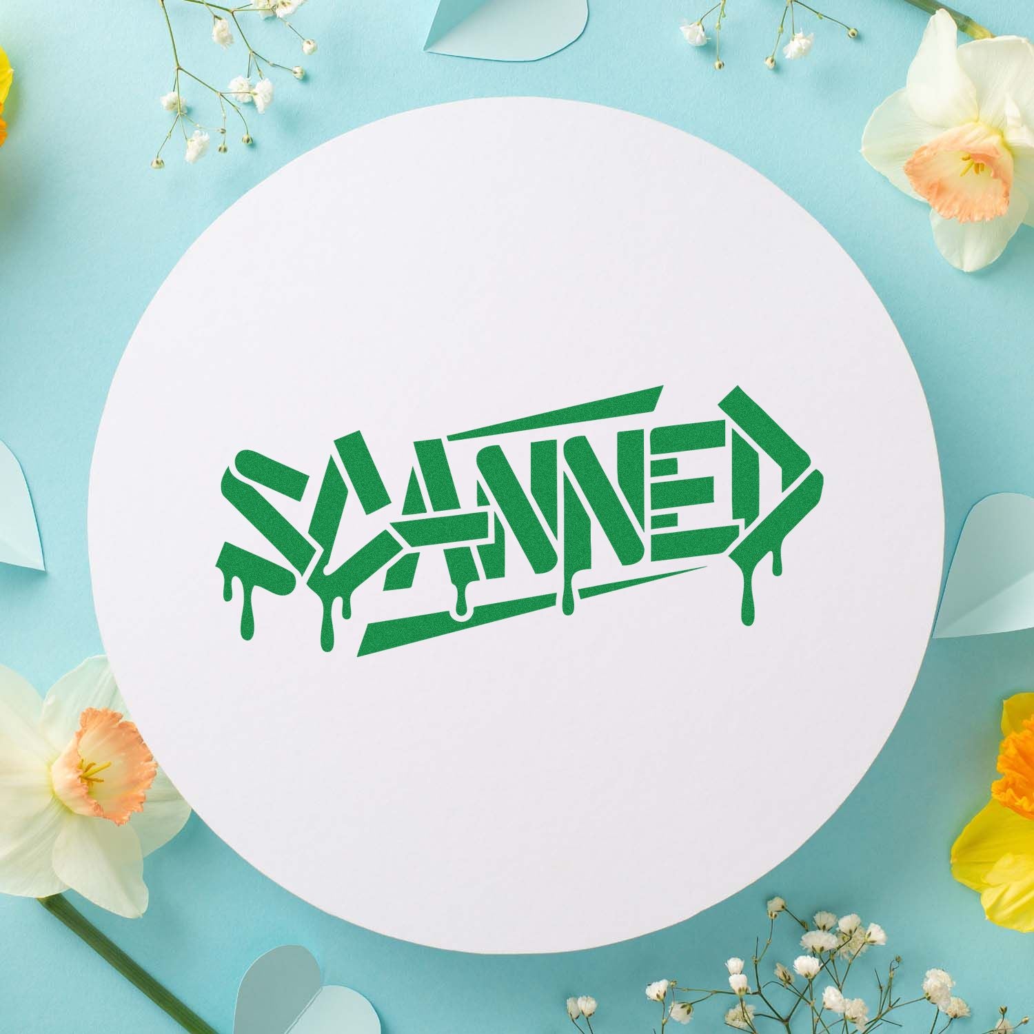 Green dripping SAVED stamp/seal on white circular card with pastel blue background and delicate flowers