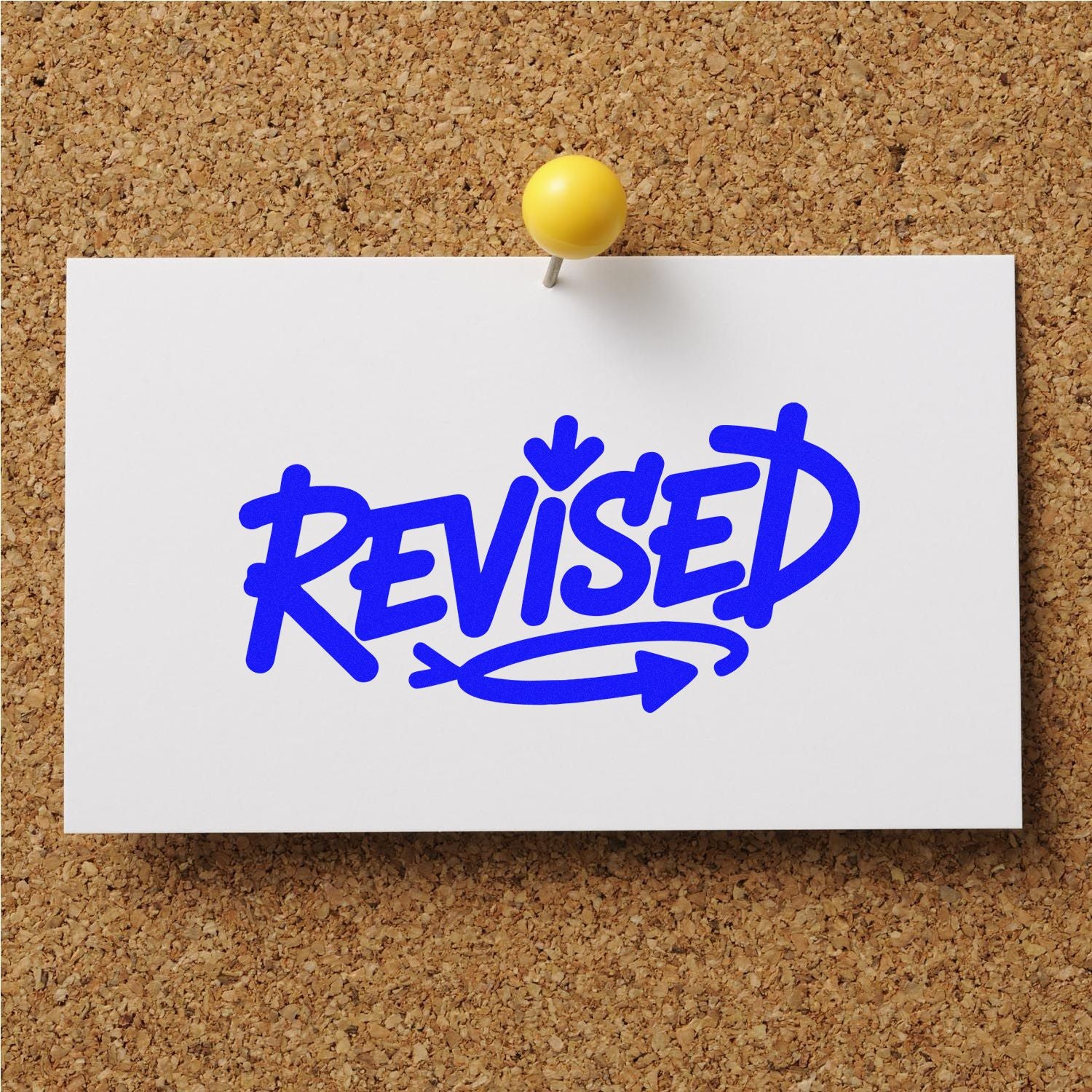 Blue REVISED stamp and seal on white card, pinned to corkboard with a yellow pushpin.