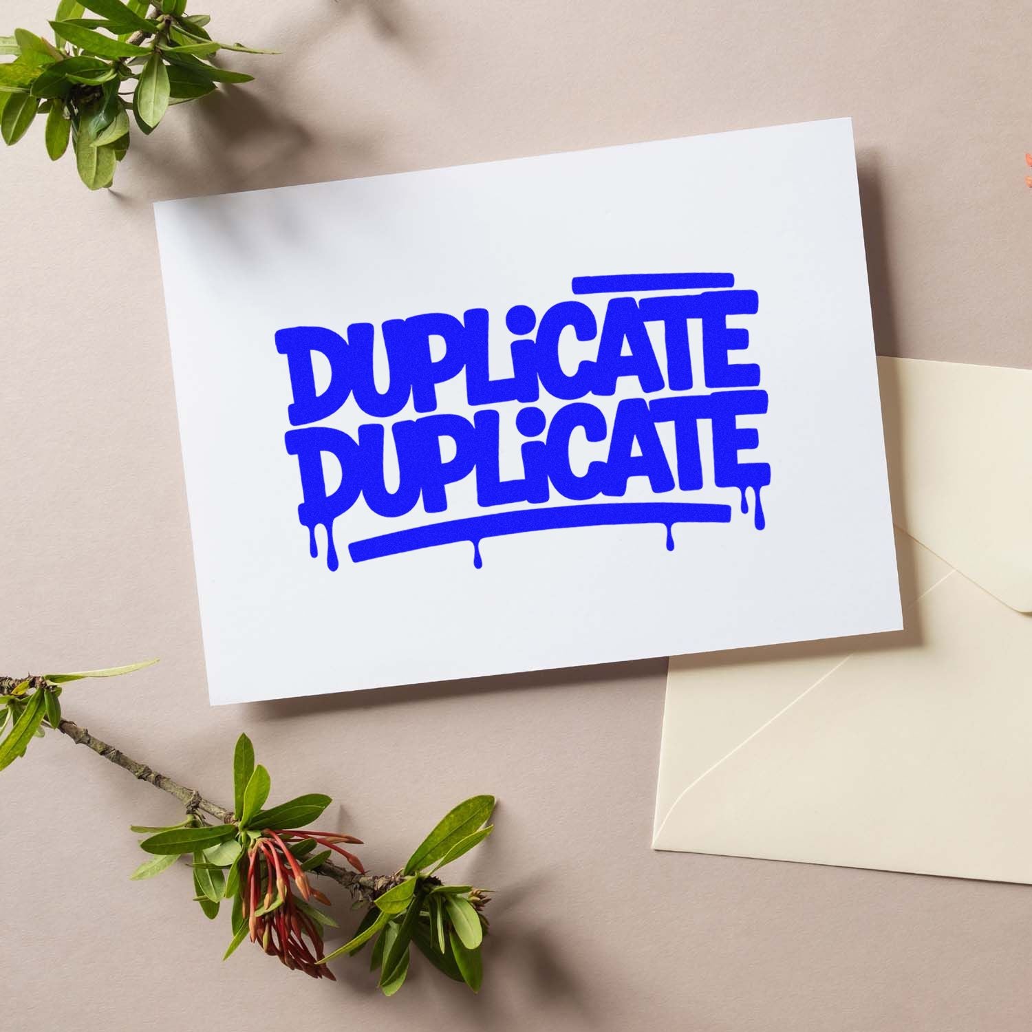 Blue duplicate stamp and seal design on white card with dripping letters, beige background, green leaves and cream envelope.