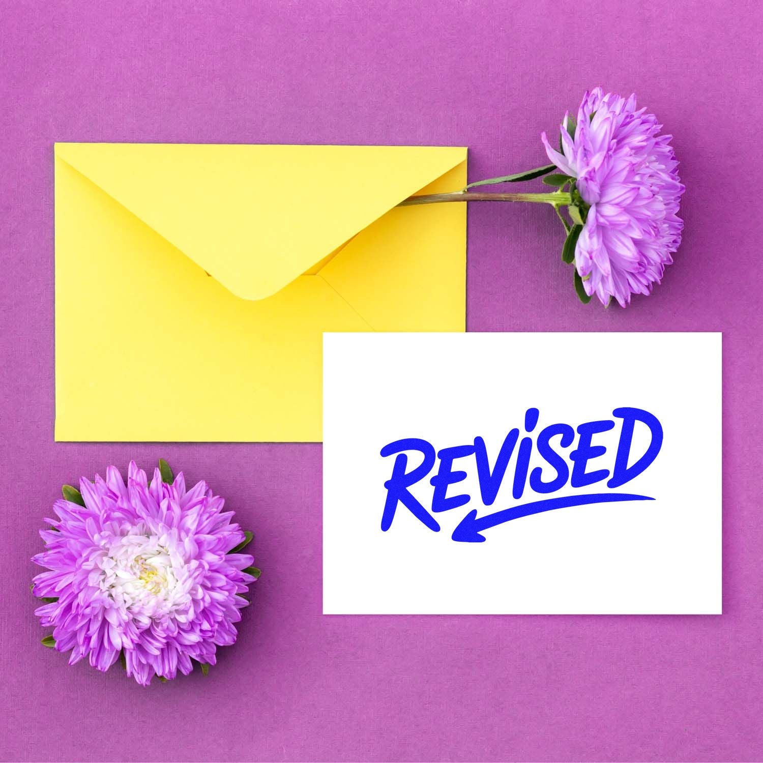 Yellow envelope and purple flowers beside a white revised stamp and seal card with blue lettering on a purple background.