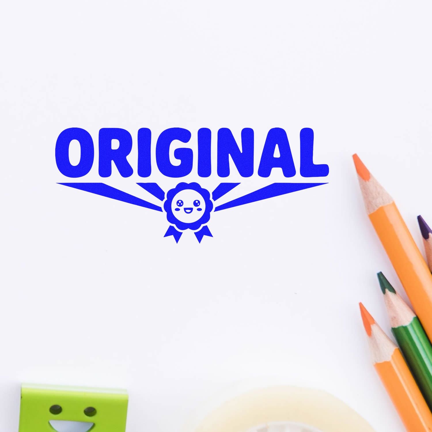 Blue ORIGINAL stamp seal with smiling ribbon emblem on white paper, beside orange, green, and purple pencils.