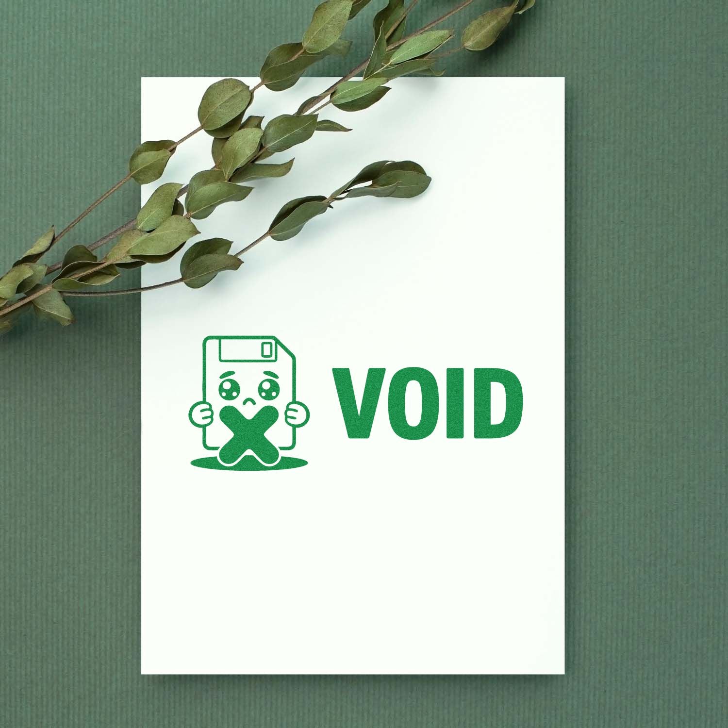 Green VOID stamp and seal design with cartoon floppy disk on white card, accented by eucalyptus leaves on textured green background.