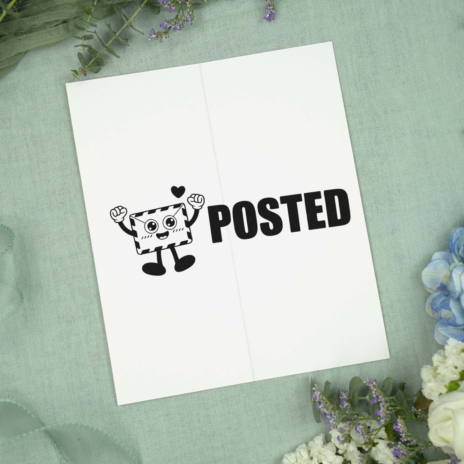 Black POSTED stamp and seal with cartoon envelope on white card, on pale green fabric with flowers.