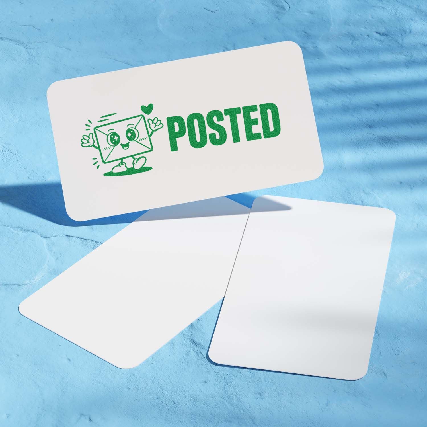 Green POSTED stamp with smiling envelope mascot on white card, beside blank seal cards on blue background.