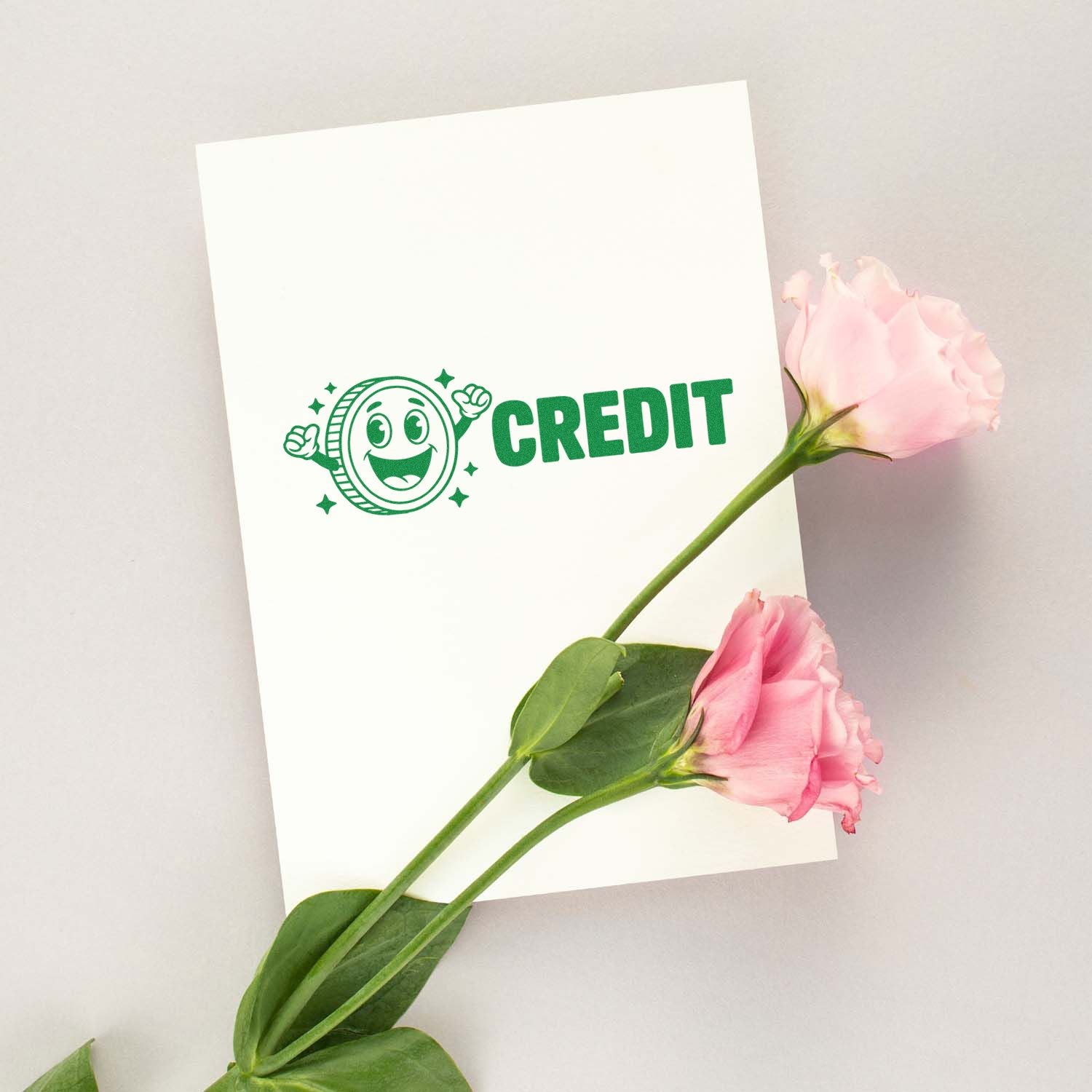 White card featuring a green CREDIT stamp seal with smiling coin icon, accented by pink roses and green stems