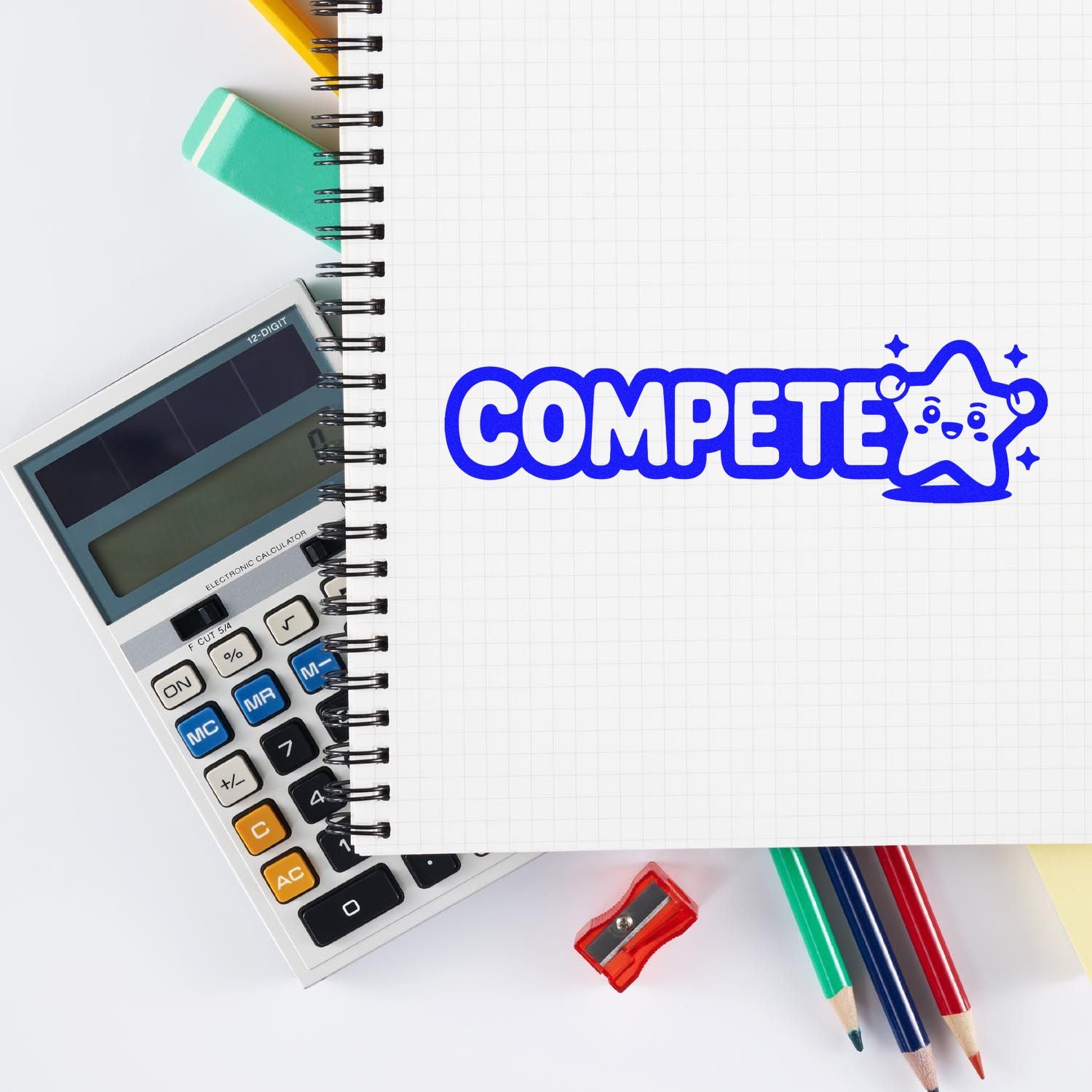 Blue COMPETE stamp seal on graph notebook, with calculator, colored pencils, eraser, and sharpener