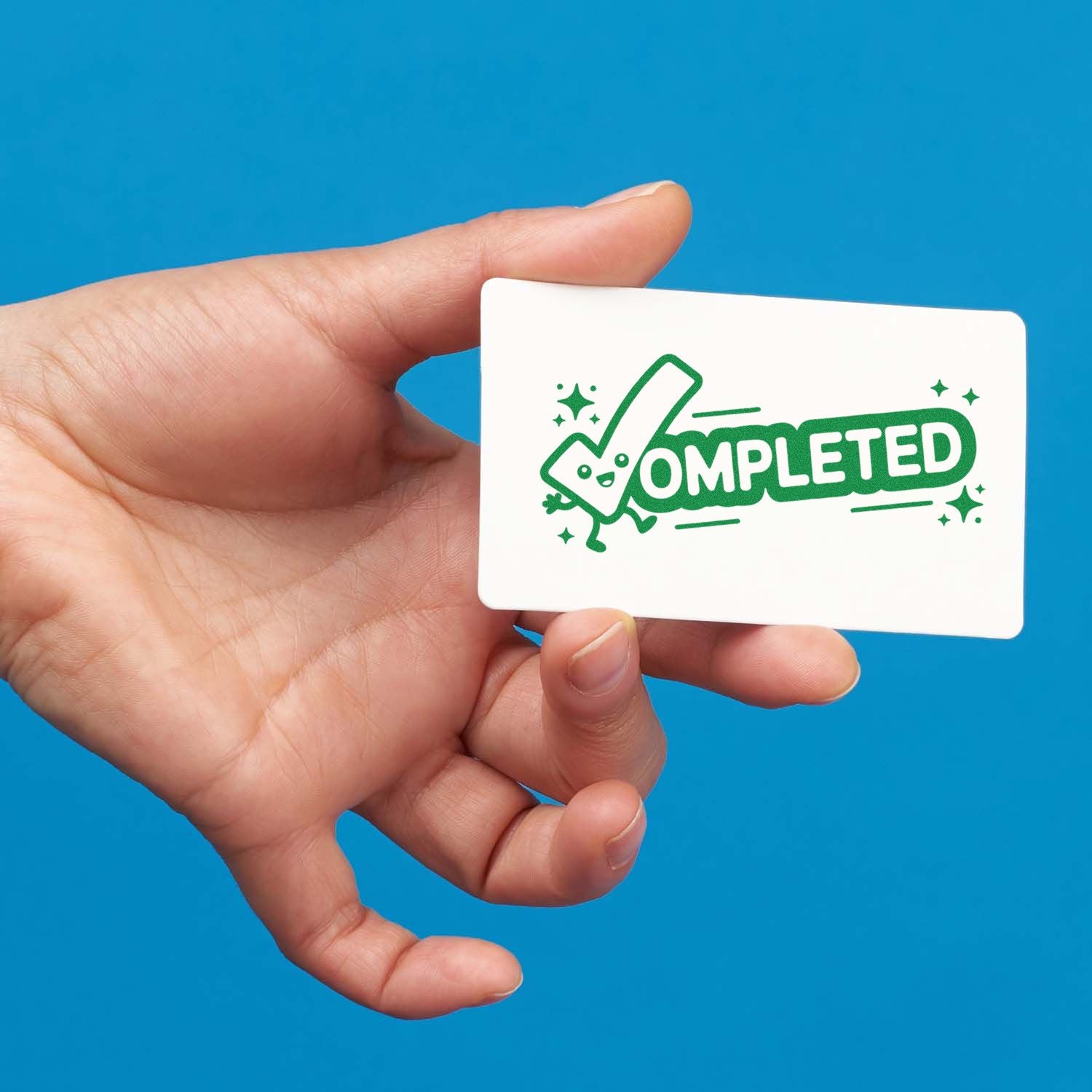 Hand holding white stamp card with green COMPLETED seal and smiling checkmark on blue background.