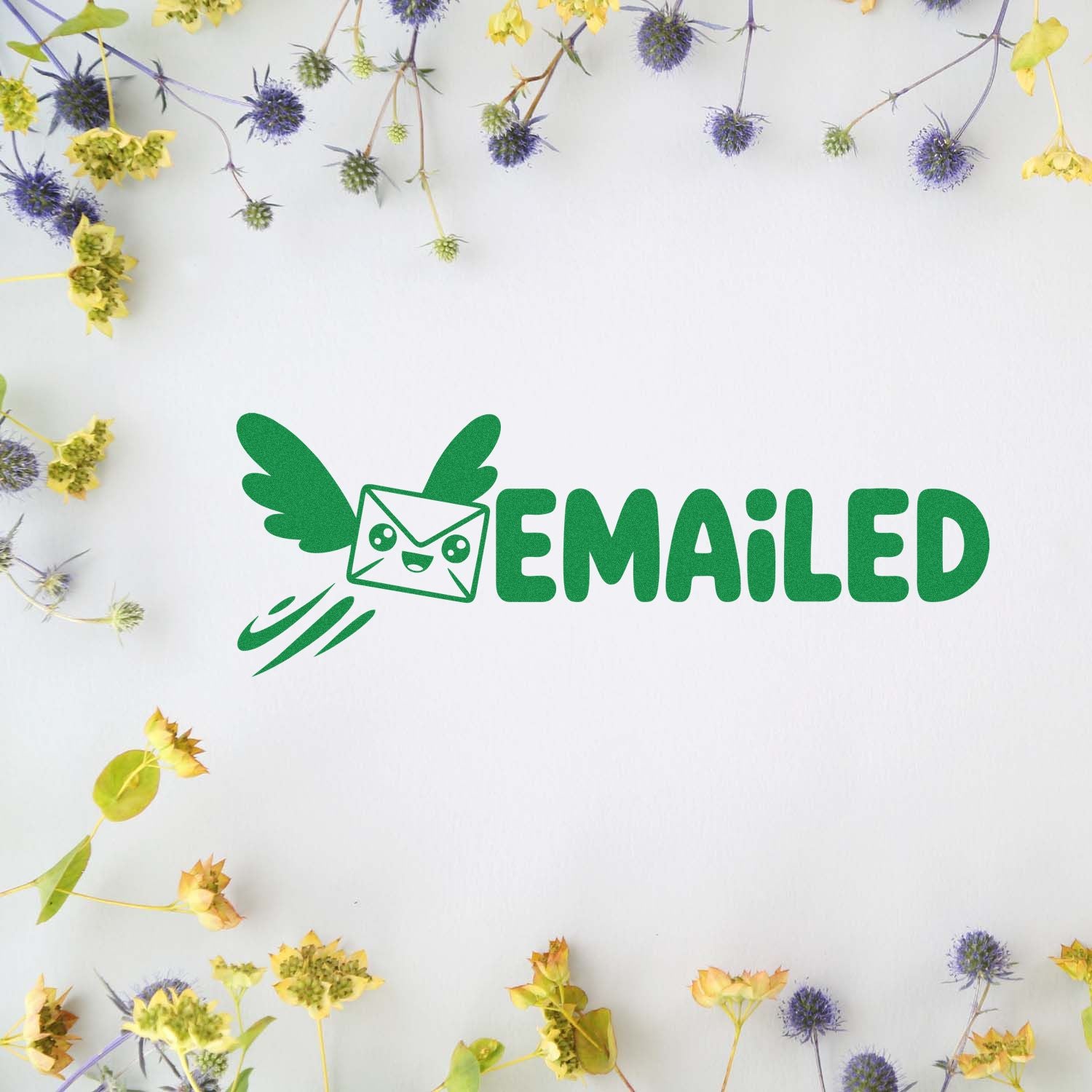 Green EMAILED stamp seal with winged envelope icon on white background, framed by yellow and purple dried flowers.