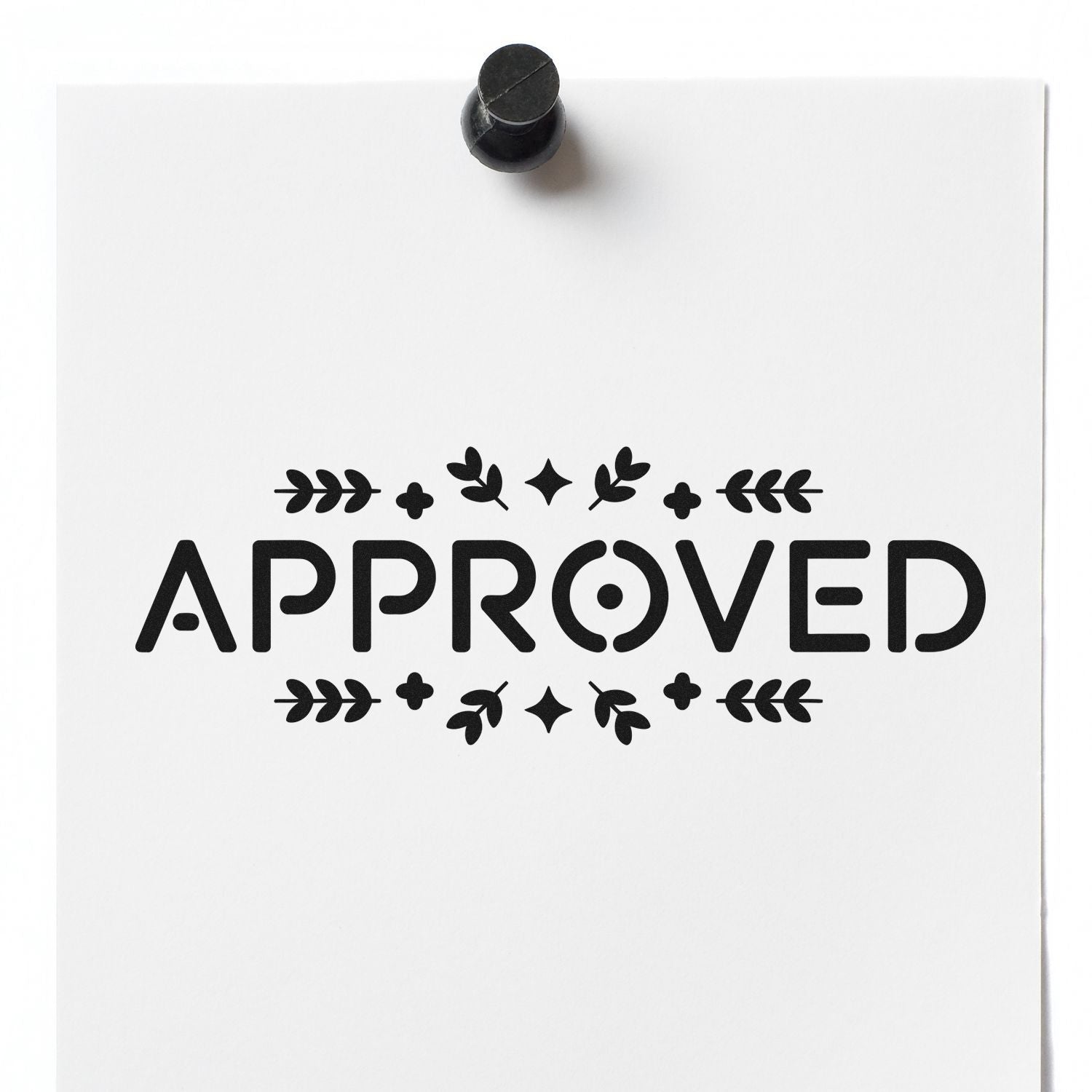 Black APPROVED rubber stamp seal on white paper, with decorative leaf accents and a black ink seal at top.
