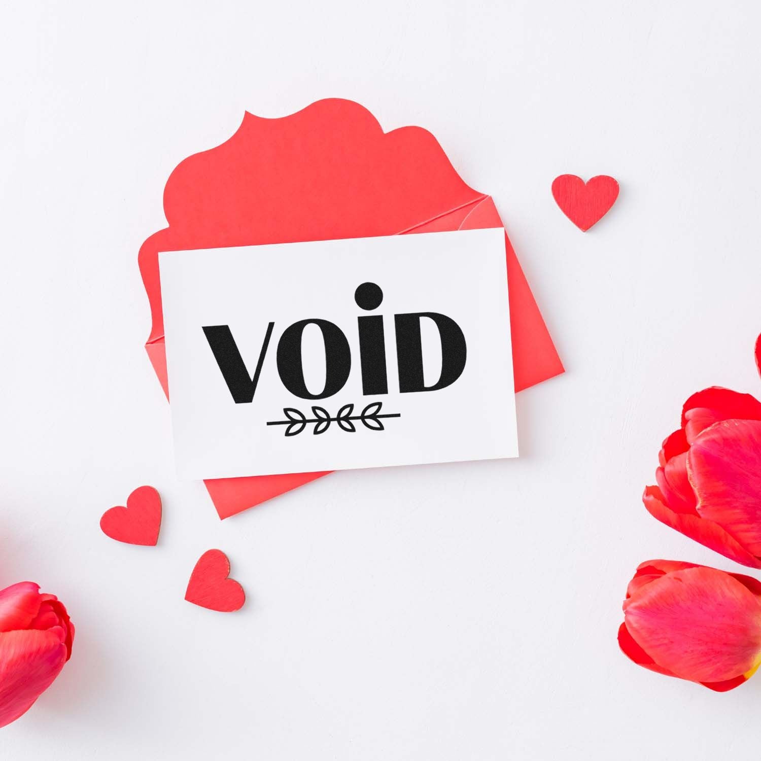 Red void stamp and seal card on pink envelope with black lettering, heart cutouts, and red flower petals.