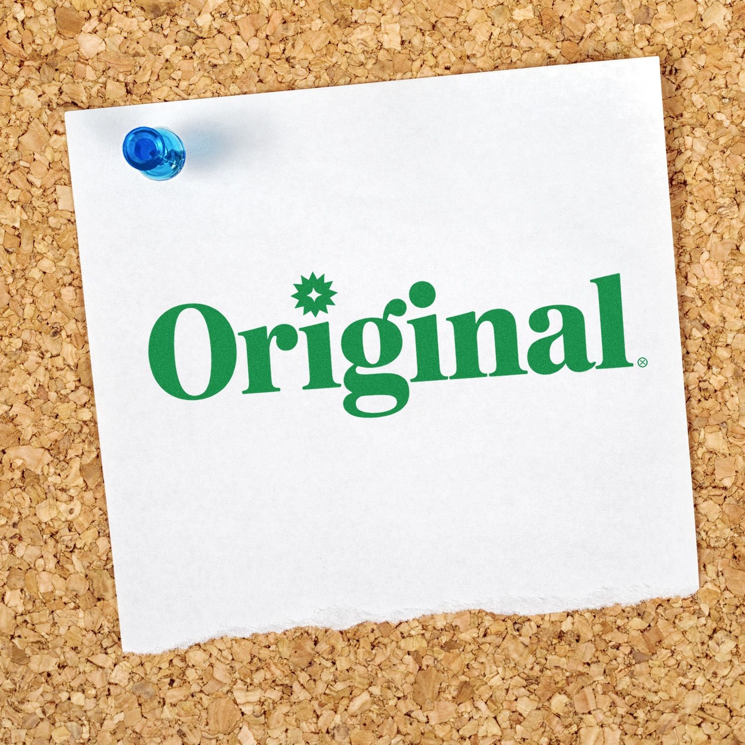 Green Original stamp and seal logo on white paper, pinned with a blue tack on a corkboard background.