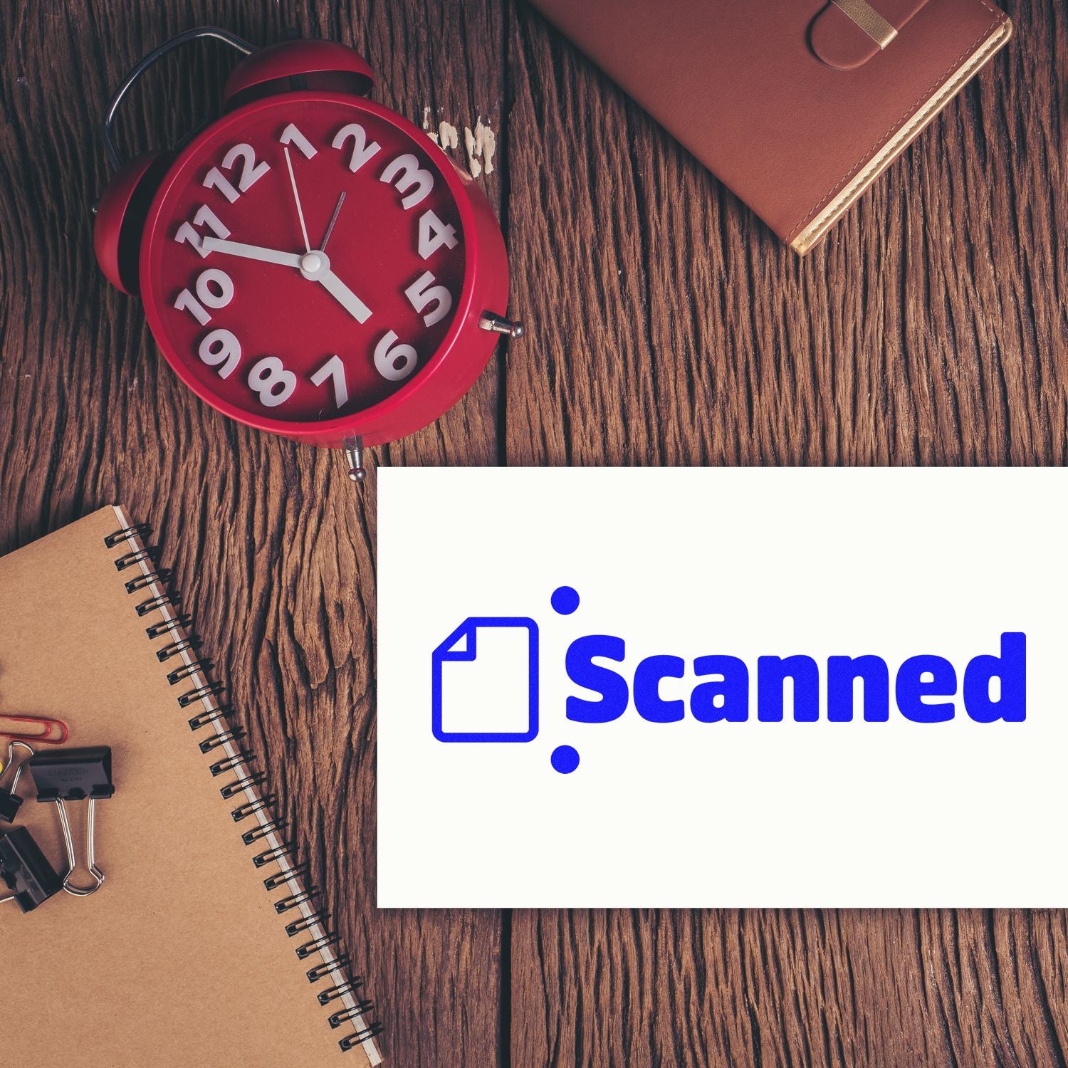Red alarm clock, notebooks, and wallet beside a blue Scanned stamp-and-seal logo on a white card.