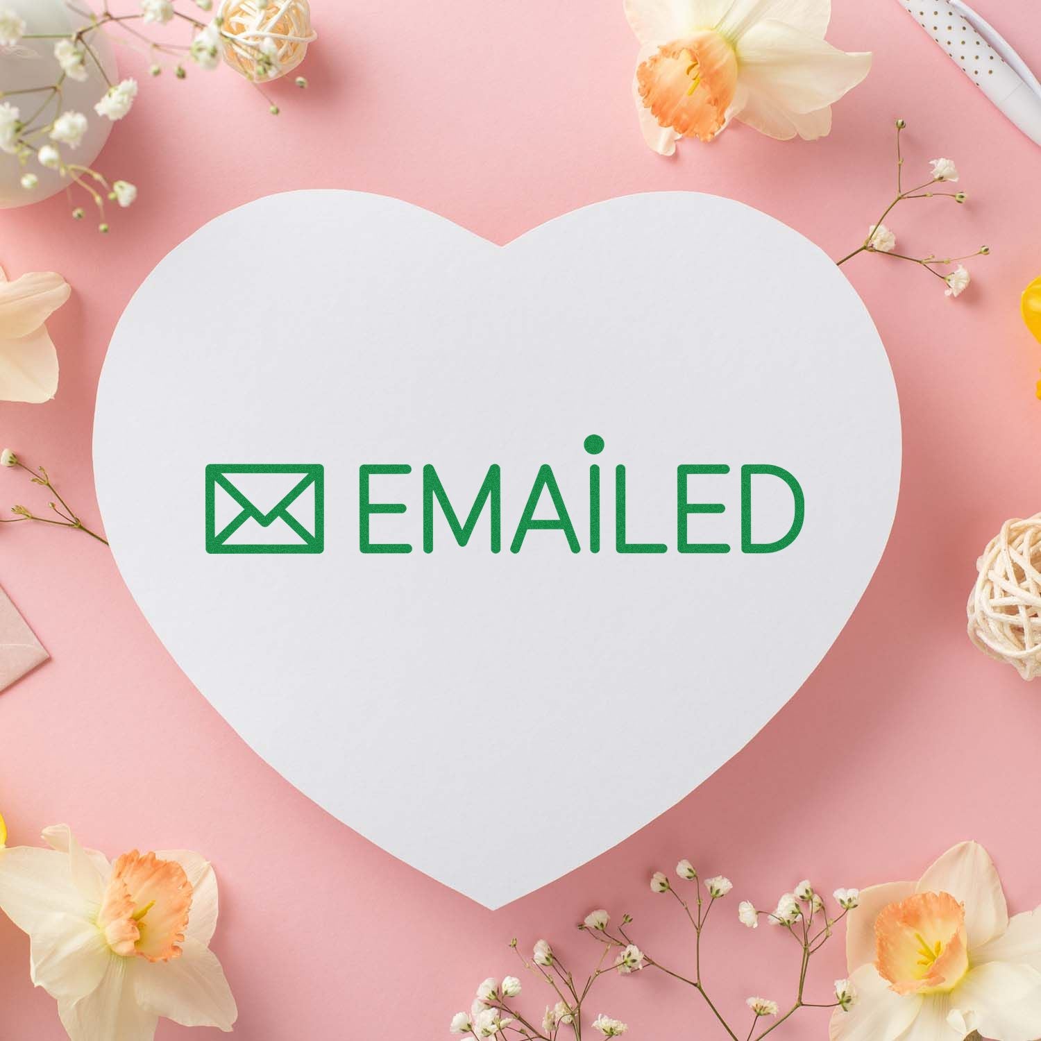 Heart-shaped white stamp seal with green envelope icon and EMAILED text on a pink floral background.