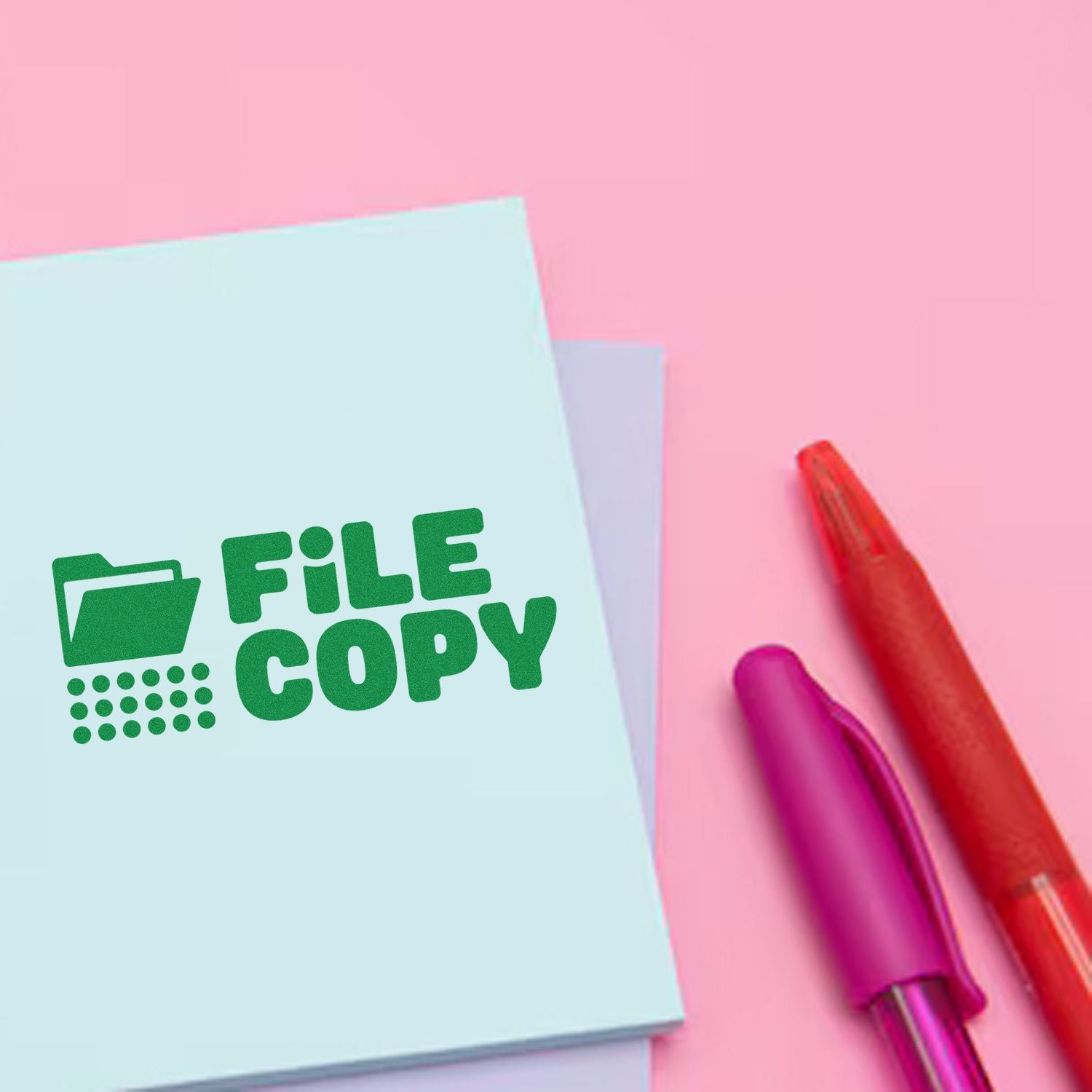 Pastel pink background with blue File Copy stamp pad and red and purple stamp seals for office documents.