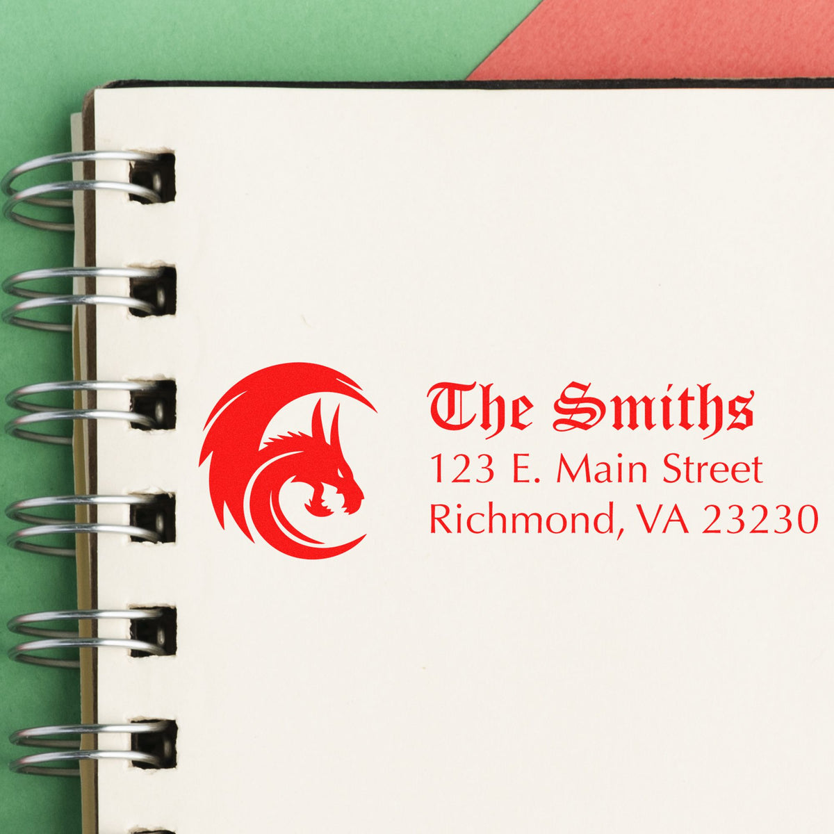Custom red stamp and seal logo for The Smiths on a white spiral-bound page, with address text and green-red background.