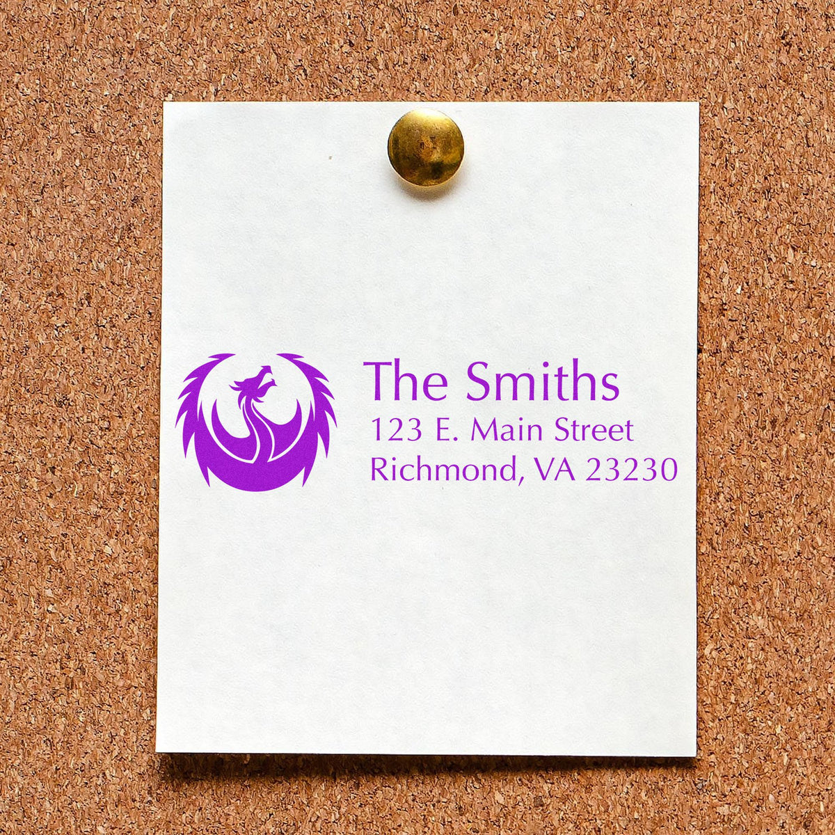 White custom stamp and seal card pinned to corkboard, featuring a purple phoenix logo and The Smiths address.