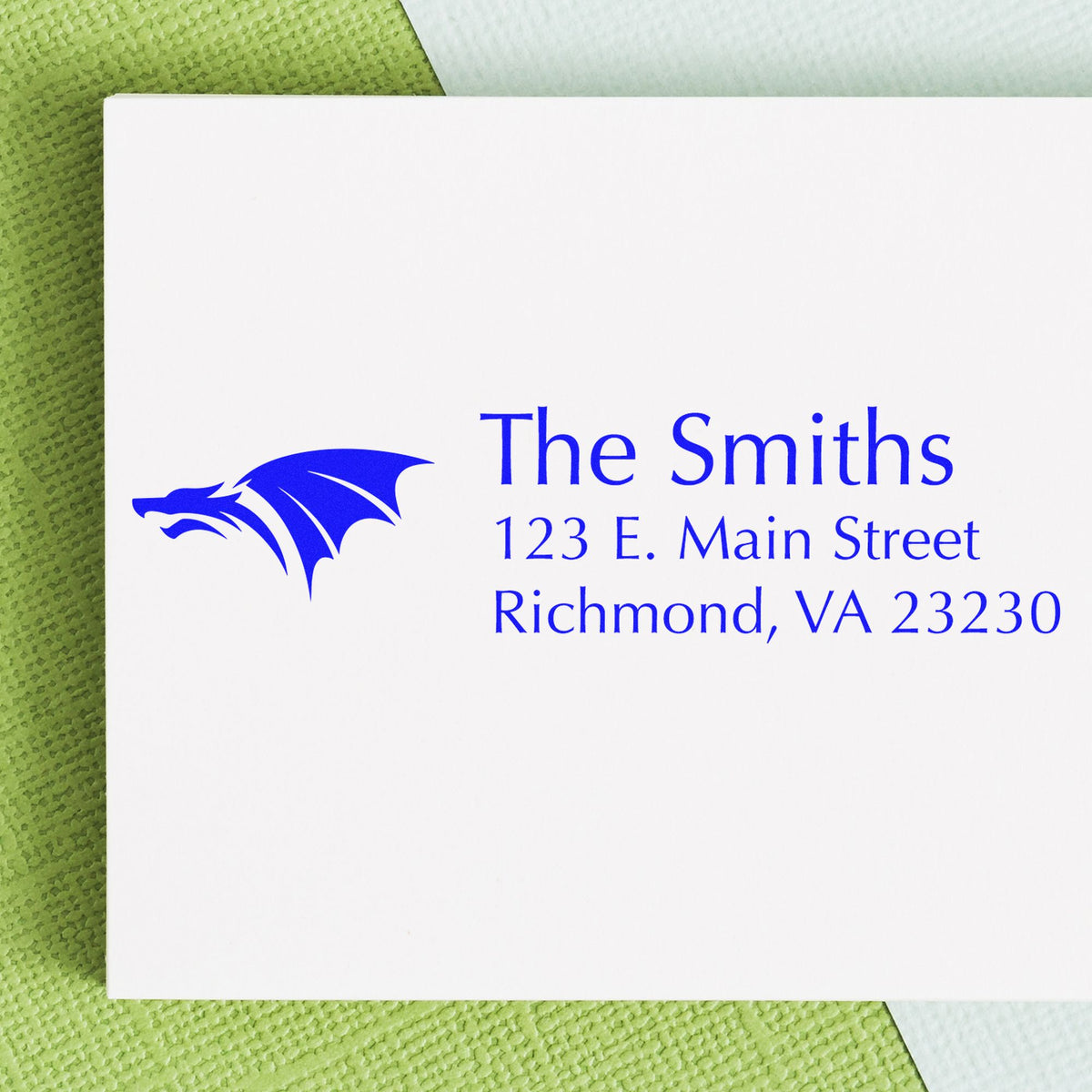 Blue custom address stamp and seal with dragon logo, The Smiths, 123 E. Main Street, Richmond, VA 23230 on white card.