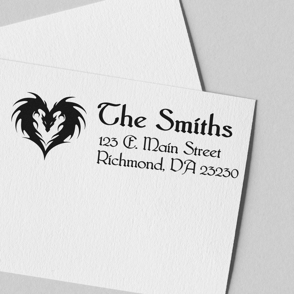 Black custom stamp and seal with heart wolf logo, The Smiths address, in black on white paper.