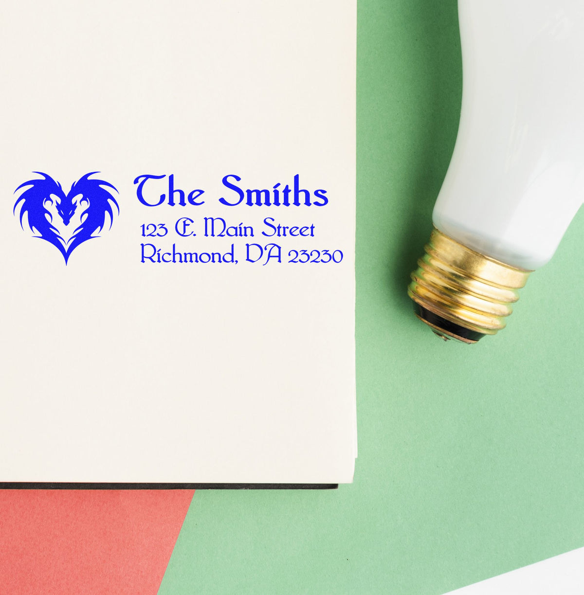 Blue custom stamp seal for The Smiths with heart logo, address, and white bulb on green background