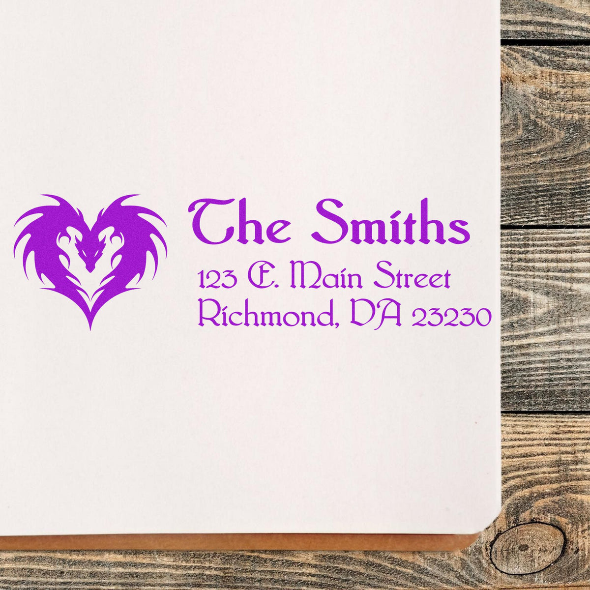 Purple custom stamp and seal with heart dragon logo, The Smiths, and address on white paper