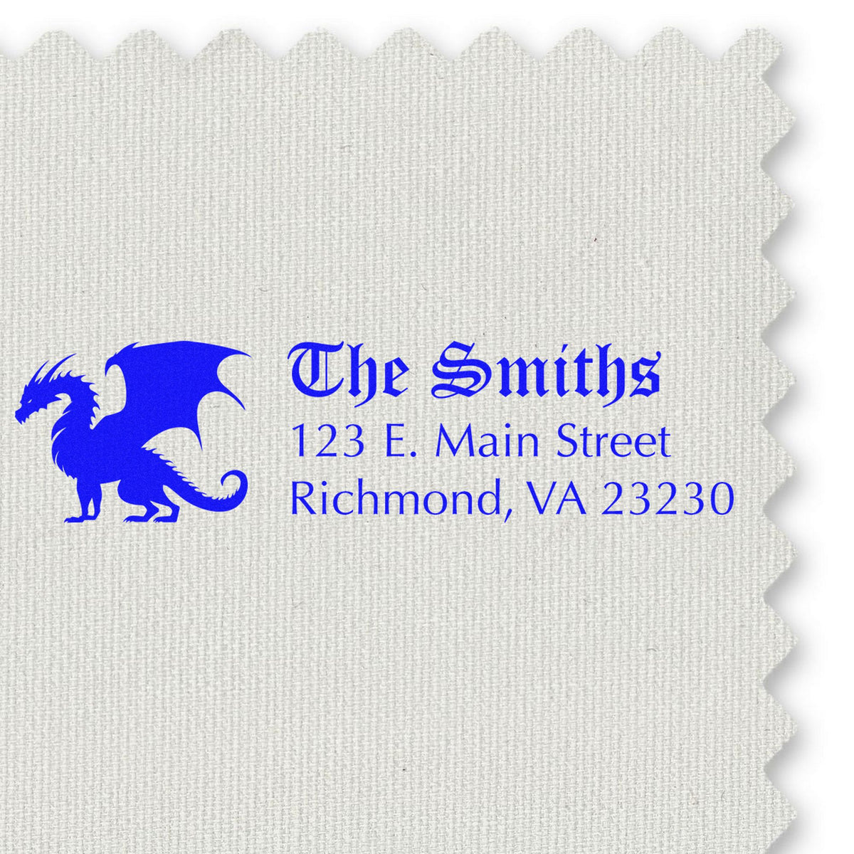 Blue custom stamp and seal on white textured fabric swatch, featuring a dragon logo and The Smiths address in blue text.