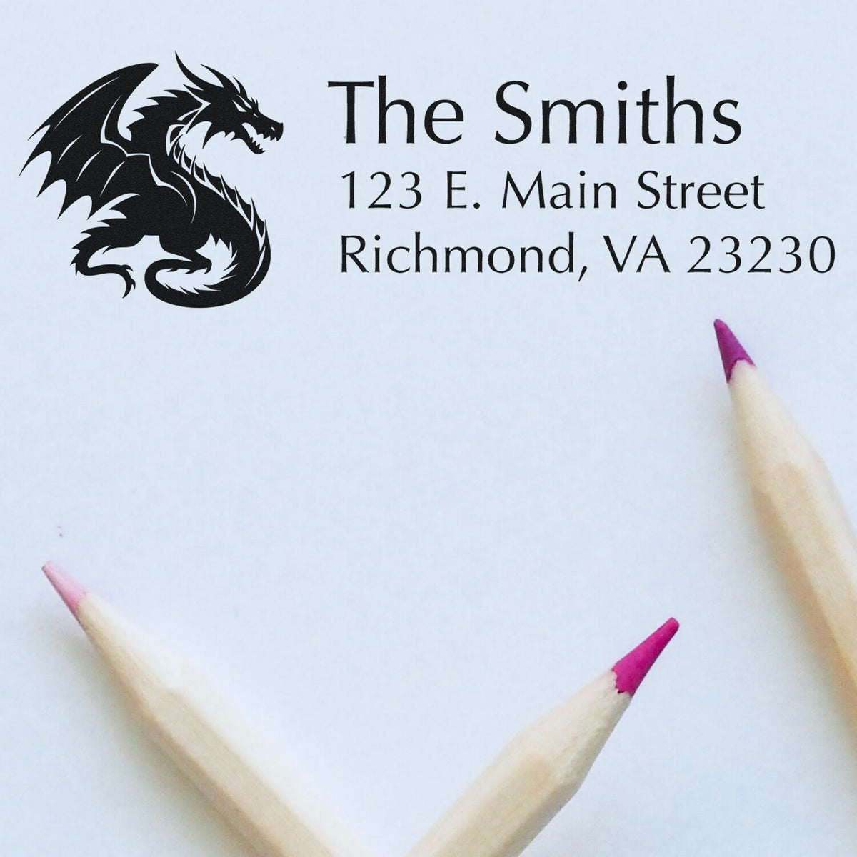 Custom black dragon address stamp for The Smiths, with seal-style text on white paper and pink-tipped pencils.