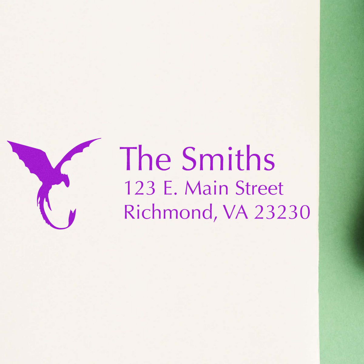 Purple custom stamp seal for The Smiths, with bird logo and address on white paper, green edge.