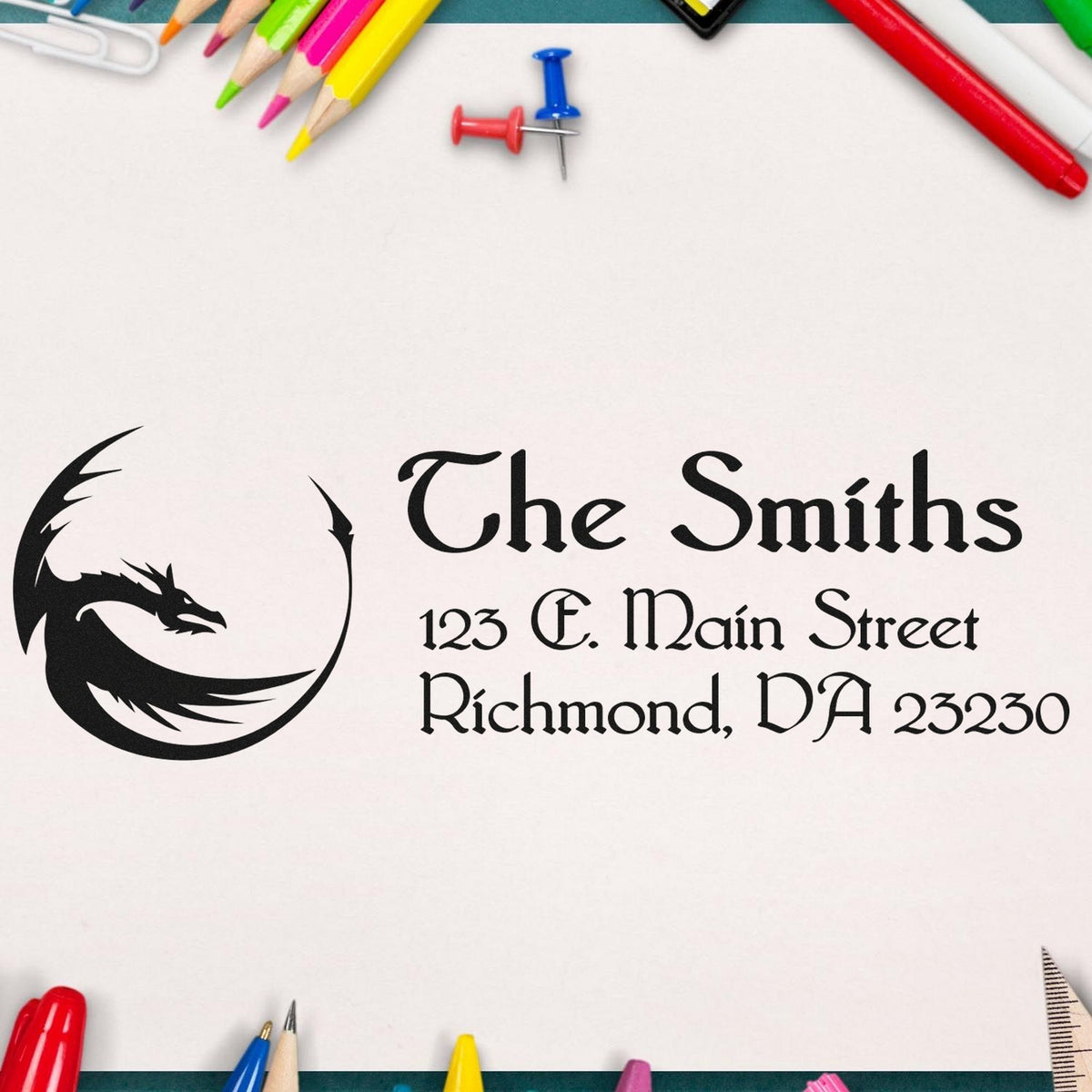 Custom black rubber stamp and seal for The Smiths, with dragon logo and address on white paper, bordered by bright pencils.