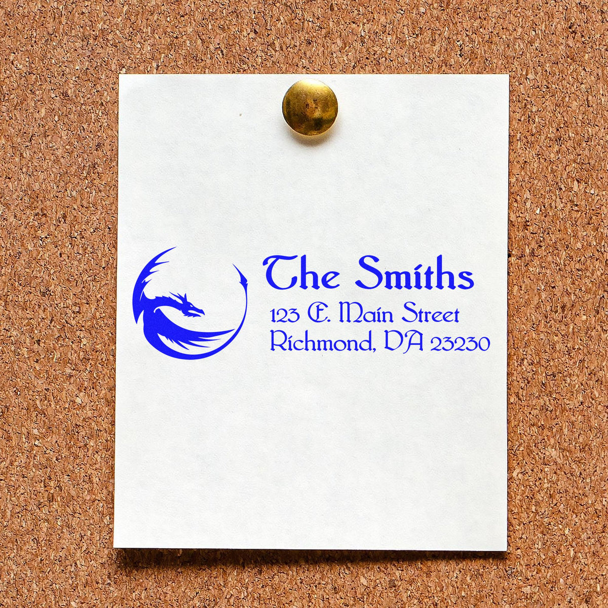 White card with blue custom stamp and seal design, dragon logo, The Smiths return address, pinned to corkboard.