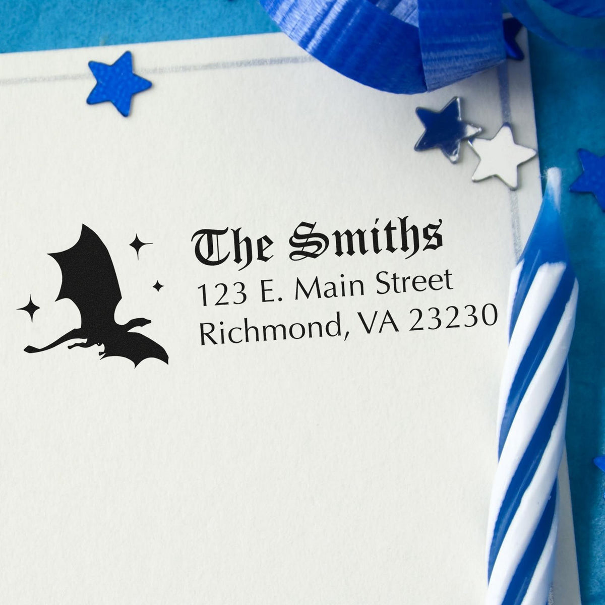 White custom stamp and seal with black bat logo, gothic The Smiths address, and blue star accents on blue ribbon.