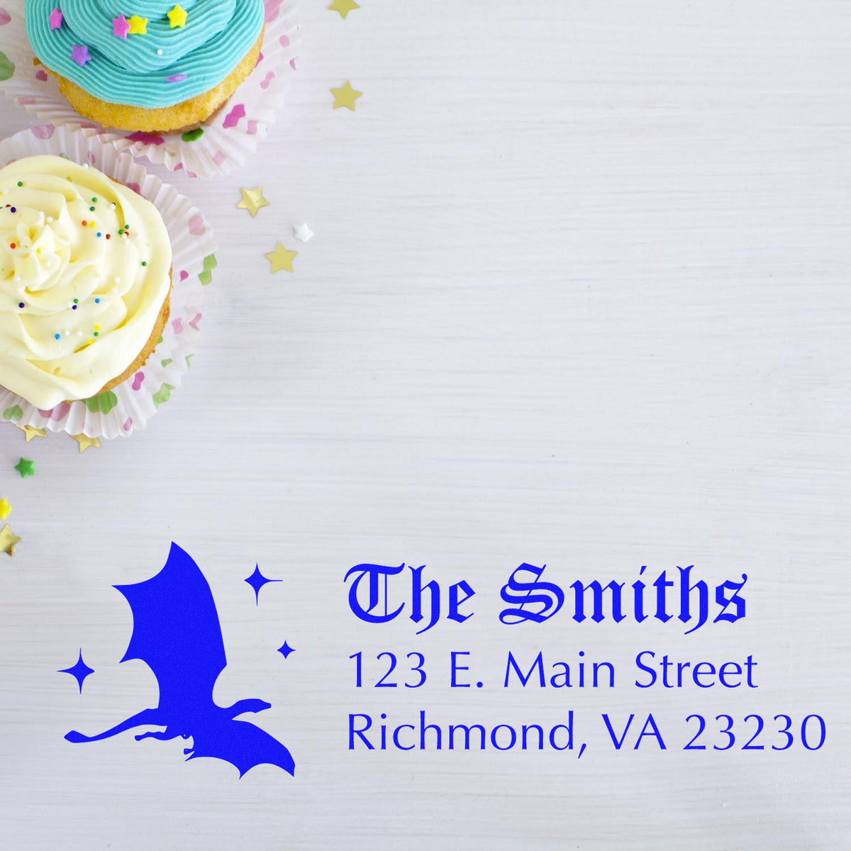 Blue custom stamp and seal for The Smiths, with address text and bat silhouette on white background, accented by pastel cupcakes.