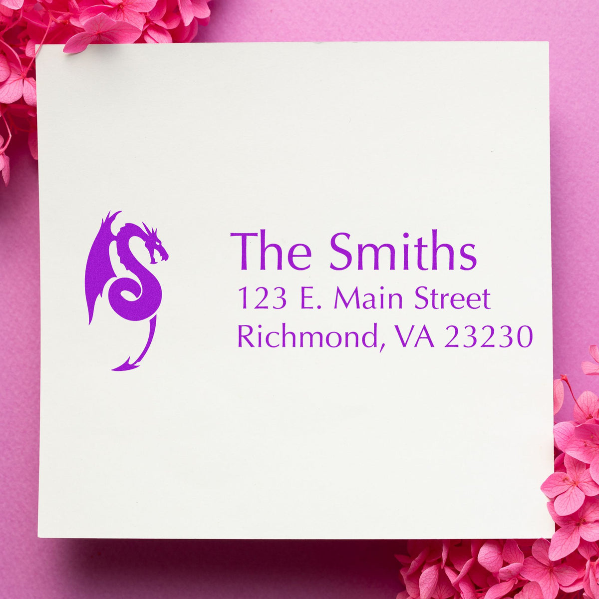 Custom purple dragon logo stamp and seal for The Smiths on a white card, with pink floral background.