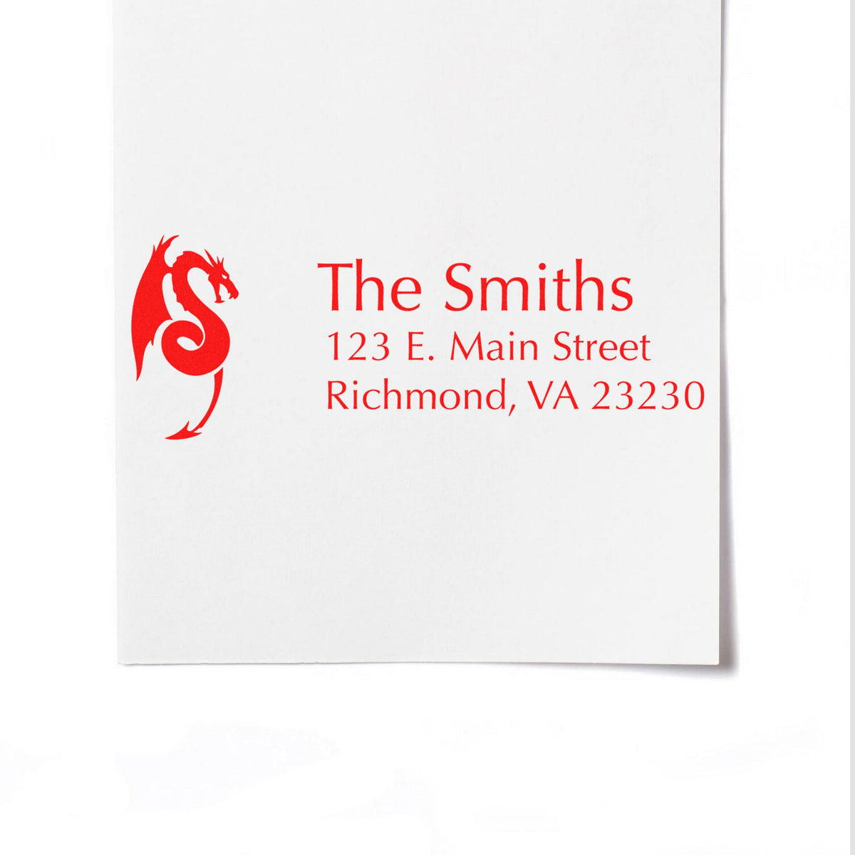 Red custom address stamp and seal with dragon monogram for The Smiths, Richmond, VA 23230 on white paper.