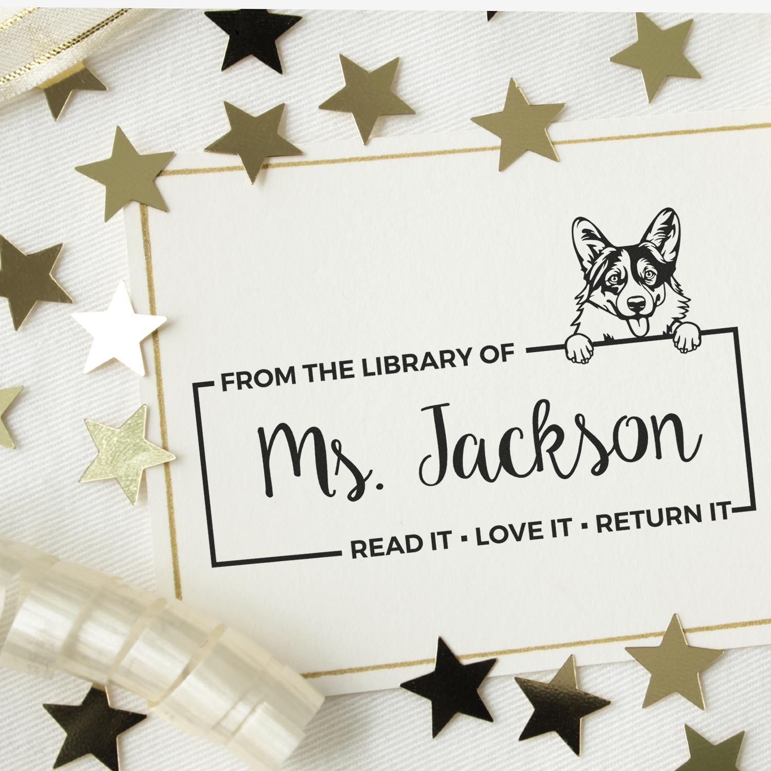 Custom black library stamp seal for Ms. Jackson with corgi illustration, framed in gold, on white background with gold and black star confetti.