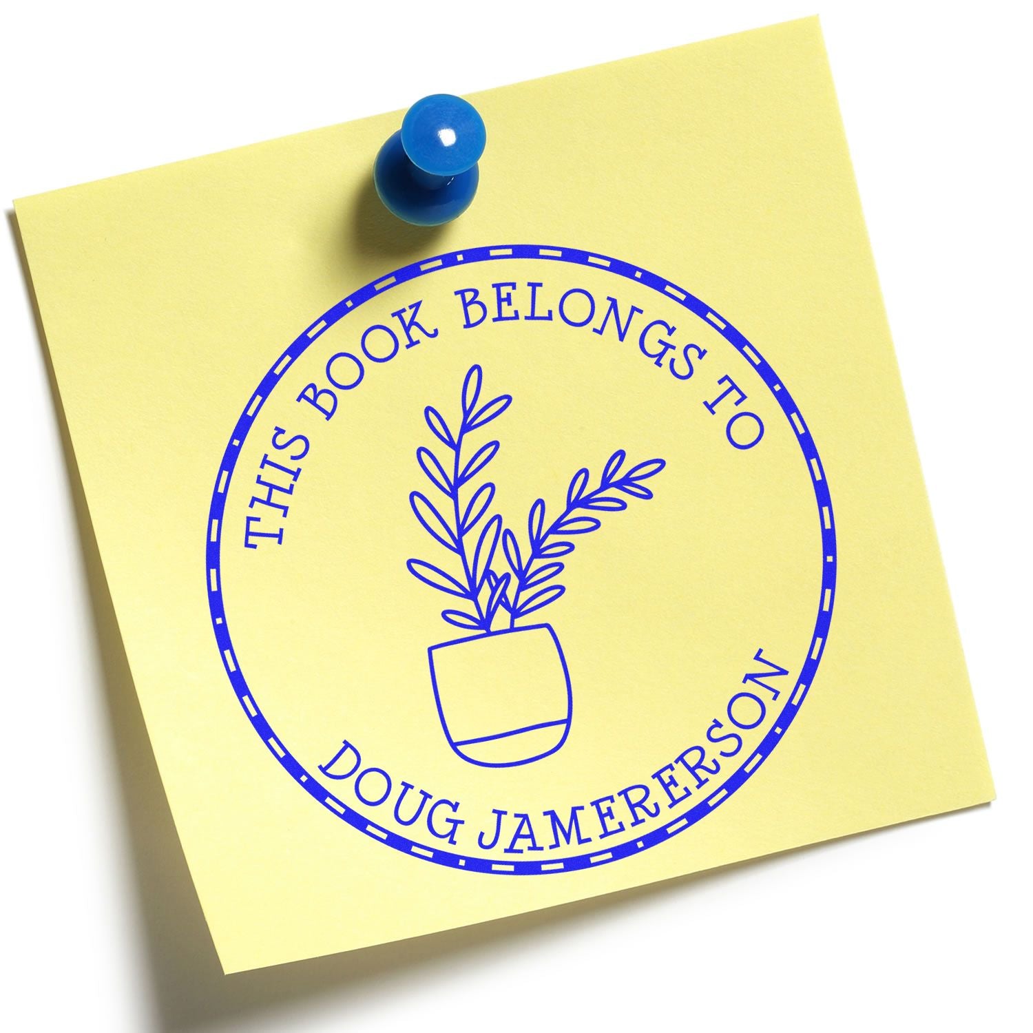 Yellow note with blue round book ownership stamp/seal reading This book belongs to Doug Jamerson and a blue pushpin.