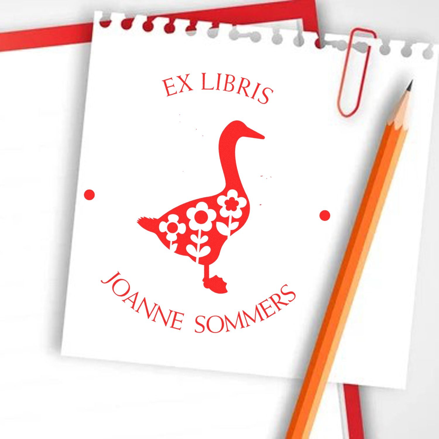 Red ex libris stamp and seal for JoAnne Sommers, featuring a floral goose design on white paper with pencil and paperclip.
