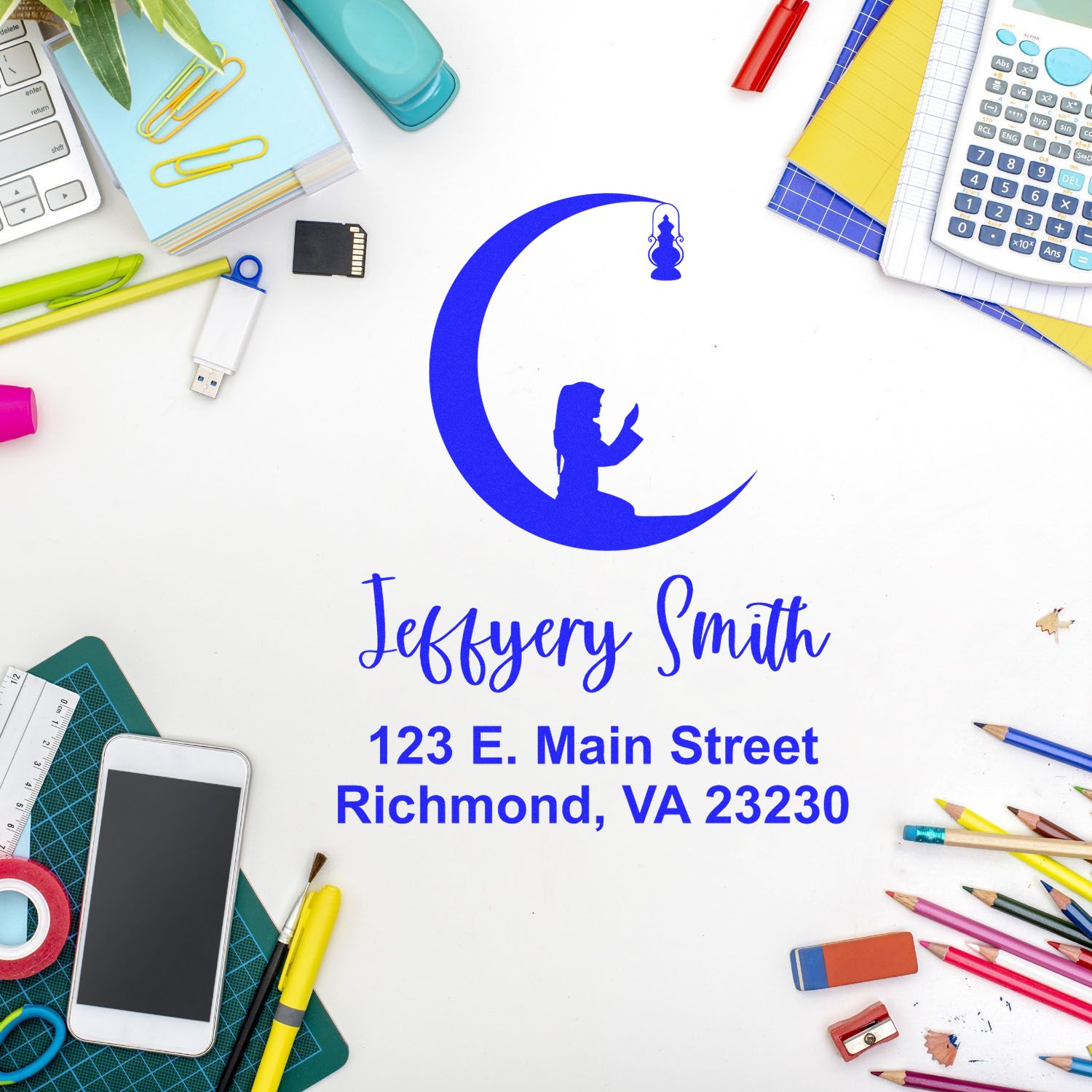 Blue custom stamp and seal with moon-and-child logo, Jeffery Smith name and Richmond, VA address on white desk, surrounded by office supplies.