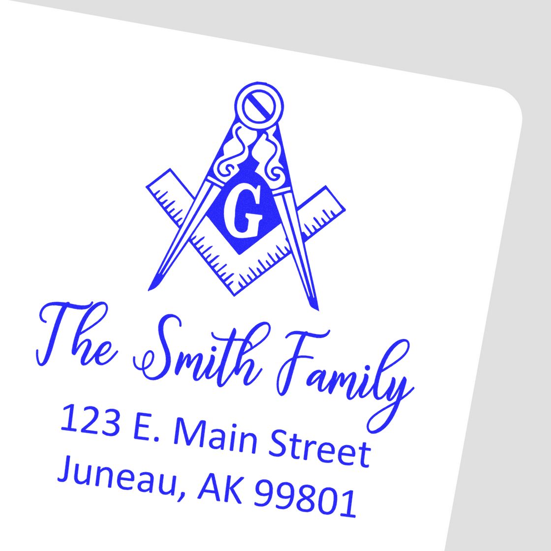 Blue custom stamp and seal featuring a compass, ruler, monogram G, and The Smith Family address.