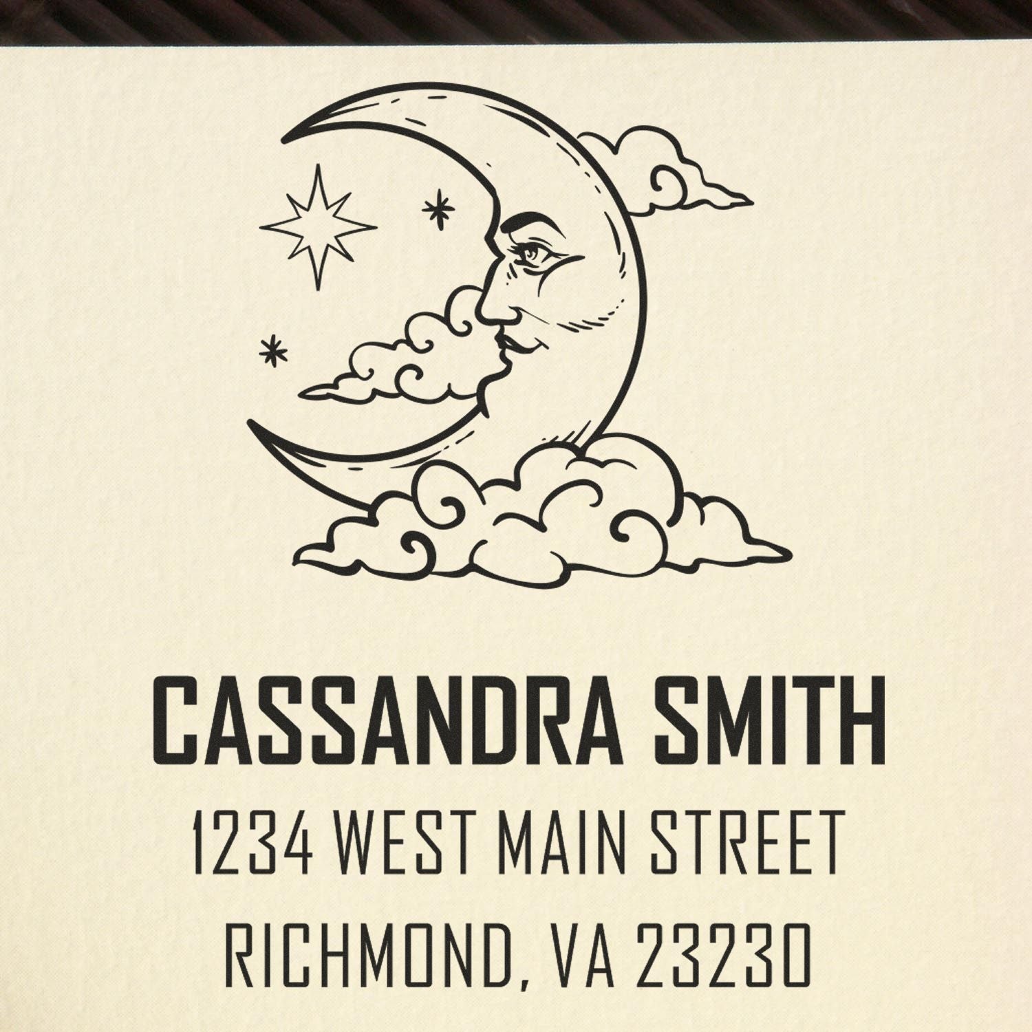 Black custom stamp seal with crescent moon and clouds above Cassandra Smith, 1234 West Main Street, Richmond, VA 23230.