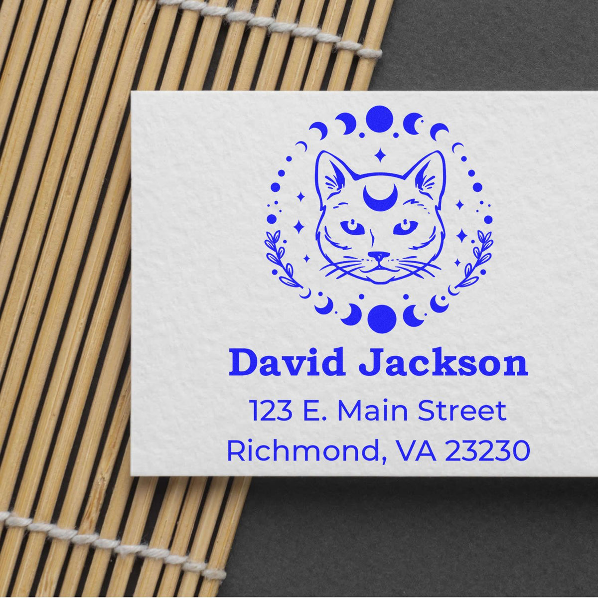 Blue custom stamp seal with cat and moon logo, David Jackson name, and Richmond, VA address on white paper.
