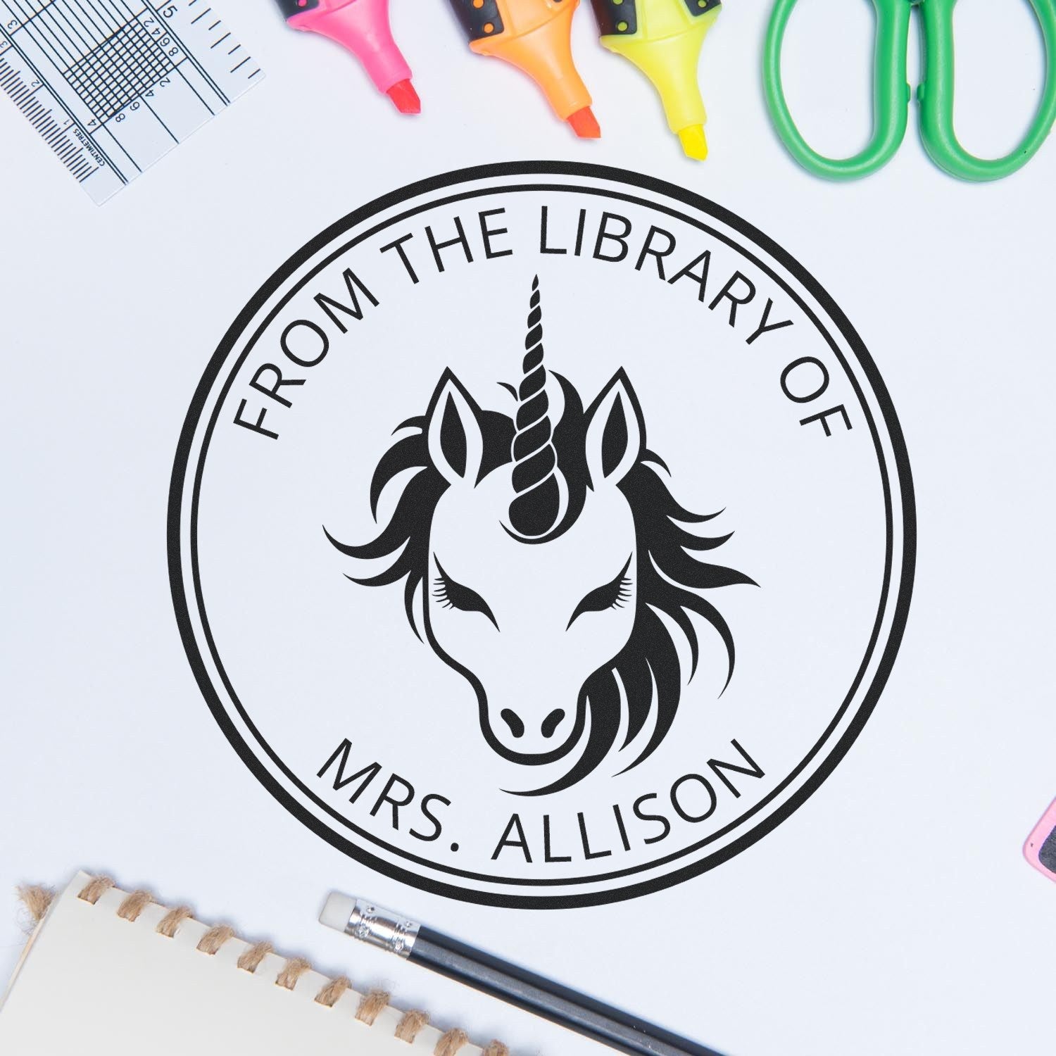 Black custom library stamp seal with unicorn emblem and From the Library of Mrs. Allison, surrounded by colorful markers.