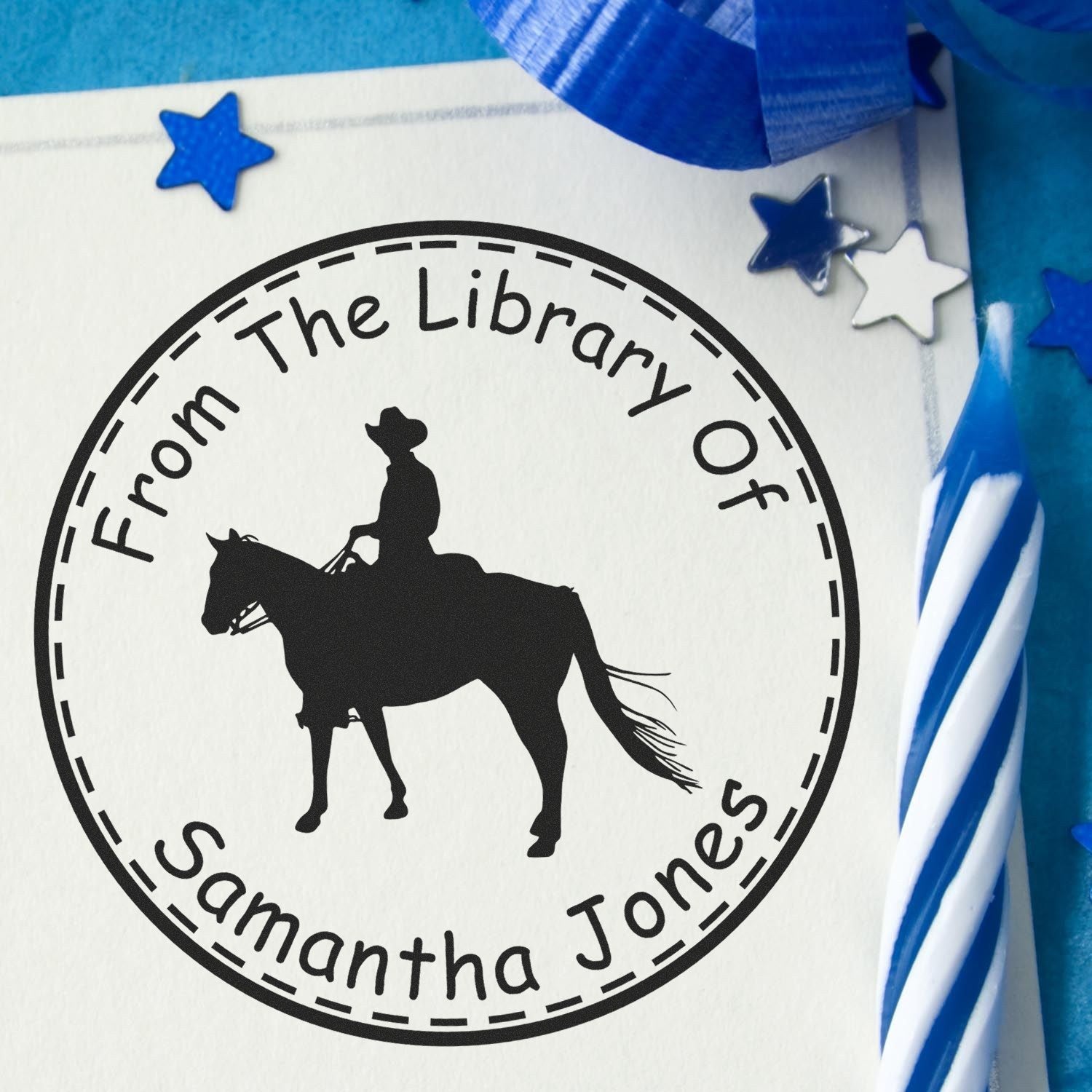 Black circular stamp seal with horse and rider silhouette, reading From The Library Of Samantha Jones, on white with blue stars.