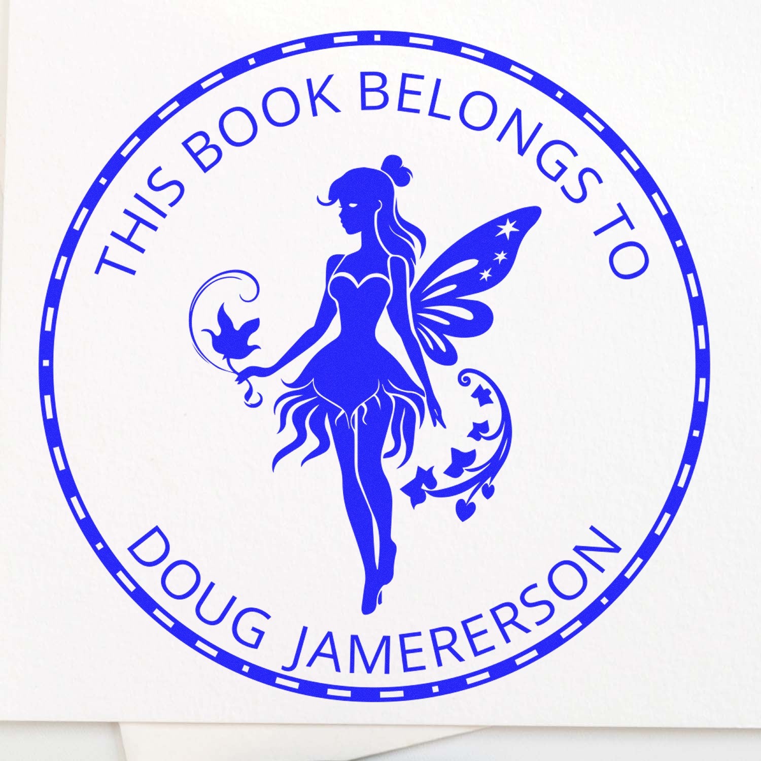 Blue circular stamp seal with fairy silhouette and This Book Belongs To Doug Jamerson text.
