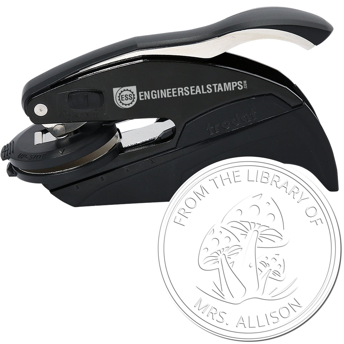 Black self-inking stamp and seal press with silver accents and circular library seal design for books.